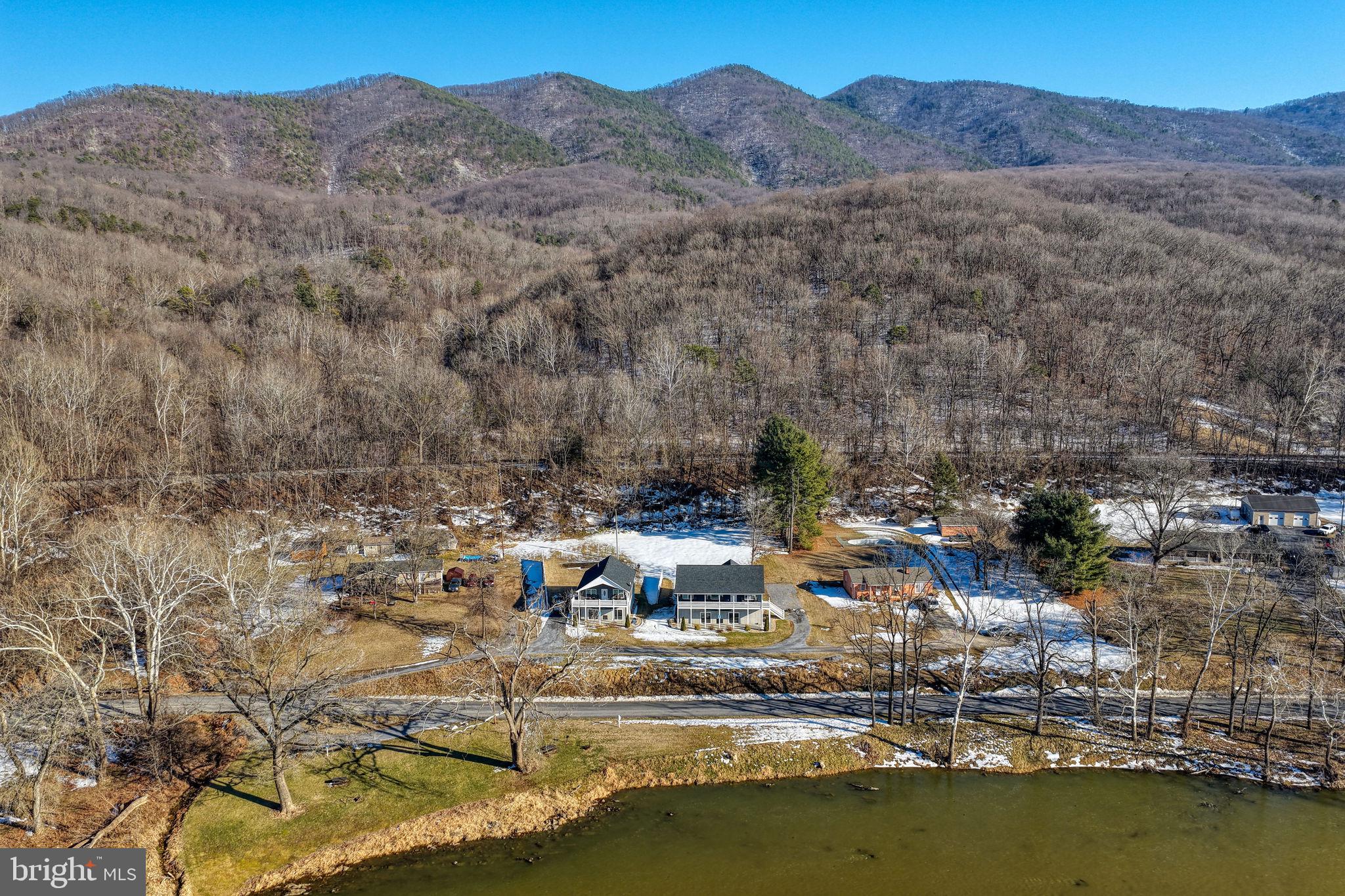 This is a unique and rare opportunity to own two houses with over 300 feet of river frontage in Page County. This property consists of 2homes: the first is 1,344 SF on unfinished basement with 3 bedrooms and 2 baths, while the second is 896 SF on unfinished basementwith 2 bedrooms and 2 baths. Both homes feature cathedral ceilings, maintenance free exterior siding and decking, granite countertops, LVP flooring, hottubs, and much more. The river frontage includes lifetime picnic tables and grills. Both homes are currently being used for a short term rental businessand are fully furnished with everything an investor would need to operate

They are both active short term rentals with direct river access making both of these properties lucrative.
Relax with the whole family at this peaceful place to stay. Amazing river front property, fishing in the river (must have fishing license), picnic table and charcoal grill along river, fire pit behind house, close to Shenandoah National Park, Massanutten Resort, Luray Caverns, New Market Battlefield and much more. There is one security camera that monitors the front door. Off street parking