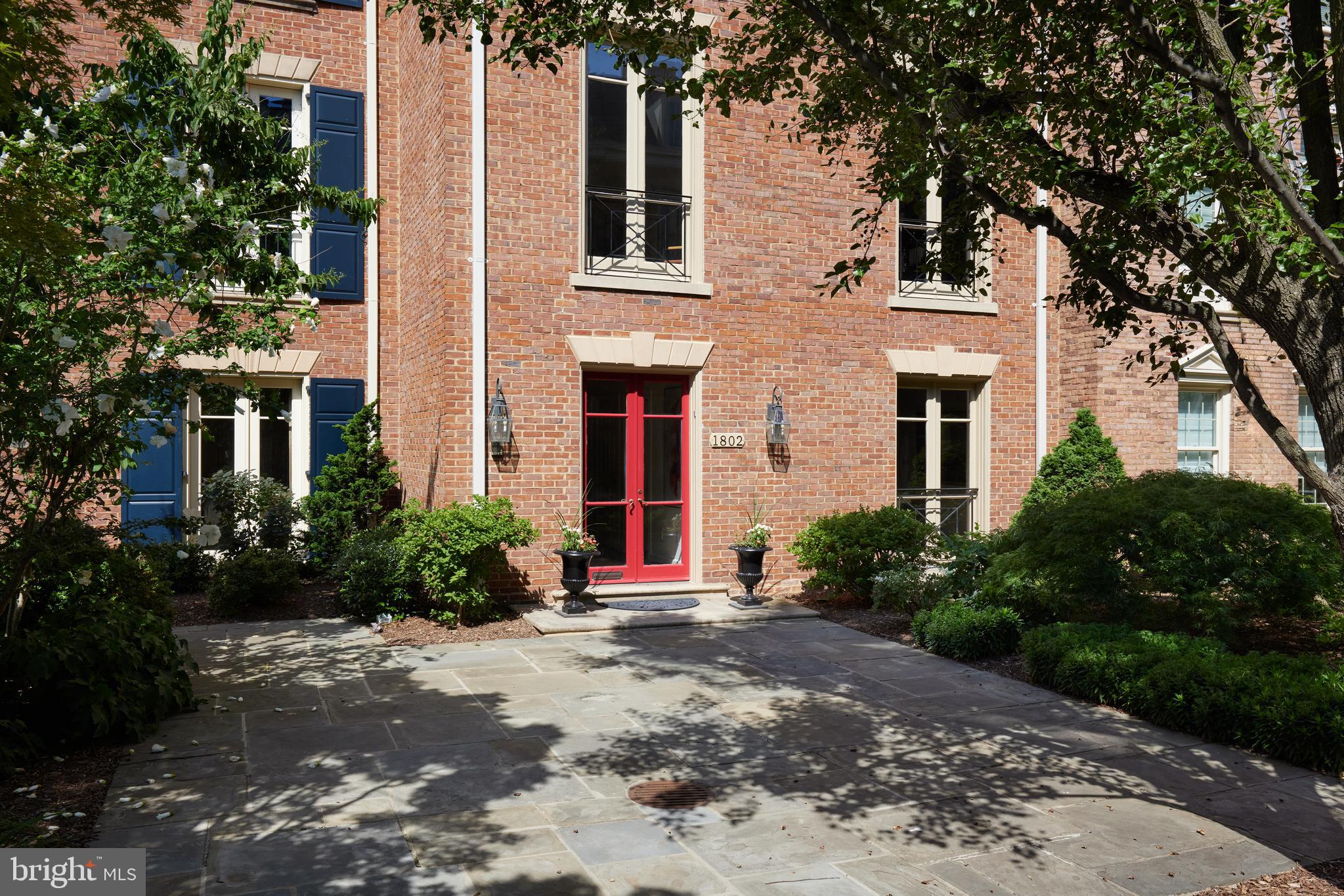 Welcome to Kalorama Square, Washington’s best-kept secret. This coveted, exclusive community of just 25 townhouses offers an idyllic retreat in the heart of the city. Enjoy the convenience of a full-time concierge, 24/7 secure entry, and an outdoor heated swimming pool. The landscaping, plantings and stone walking paths create an elegant and serene context for your home.<br><br>1802, one of Kalorama Square’s premier homes overlooking Mitchell Park, boasts nearly 5,000 square feet of luxurious living space spread across five levels, all served by the elevator. Highlights include soaring ceilings and generously proportioned rooms. The large French windows bathe rooms in natural light and display one spectacular sunset after another over the Park.<br><br>The home has reserved, secure garage parking spaces for FOUR cars!<br><br>The welcoming Foyer opens to an inviting Study complete with a Powder Room and views of the shared garden mews and the lovely flickering gas lanterns. The well-appointed center Kitchen adjoins the spacious Formal Dining Room. From there you find your own private, professionally landscaped garden and terrace with a retractable awning for entertaining al fresco. Among the herbs, flowers and your flowering trees, good cheer is inevitable. <br><br>An open staircase leads to the grand Living Room with gas fireplace. Panoramic views of the park add to the impressive architecture of the room. The spacious Library overlooking the Courtyard, with custom mahogany built-ins, is another feature on this level which includes an additional Powder Room.<br><br>The third floor is dedicated to the Primary Suite with dressing room, bespoke built-ins and custom shelving. Bedroom Two has an ensuite bath, generous closet and a sweeping view of the city.<br><br>The upper level features two expansive Bedroom suites, each with its own Bath and ample closet space.<br><br>The lower level has a Guest Room and Yoga Room well as a Powder Room and Large Laundry Room. The central heating and cooling systems are zoned.<br><br>While serene and tucked away, this residence is a short walk to Mitchell Park, shopping, dining, and the Dupont Metro. The internationally renowned Phillips Collection Art Museum is also an easy walk, and their weekend musical events are simply marvelous.