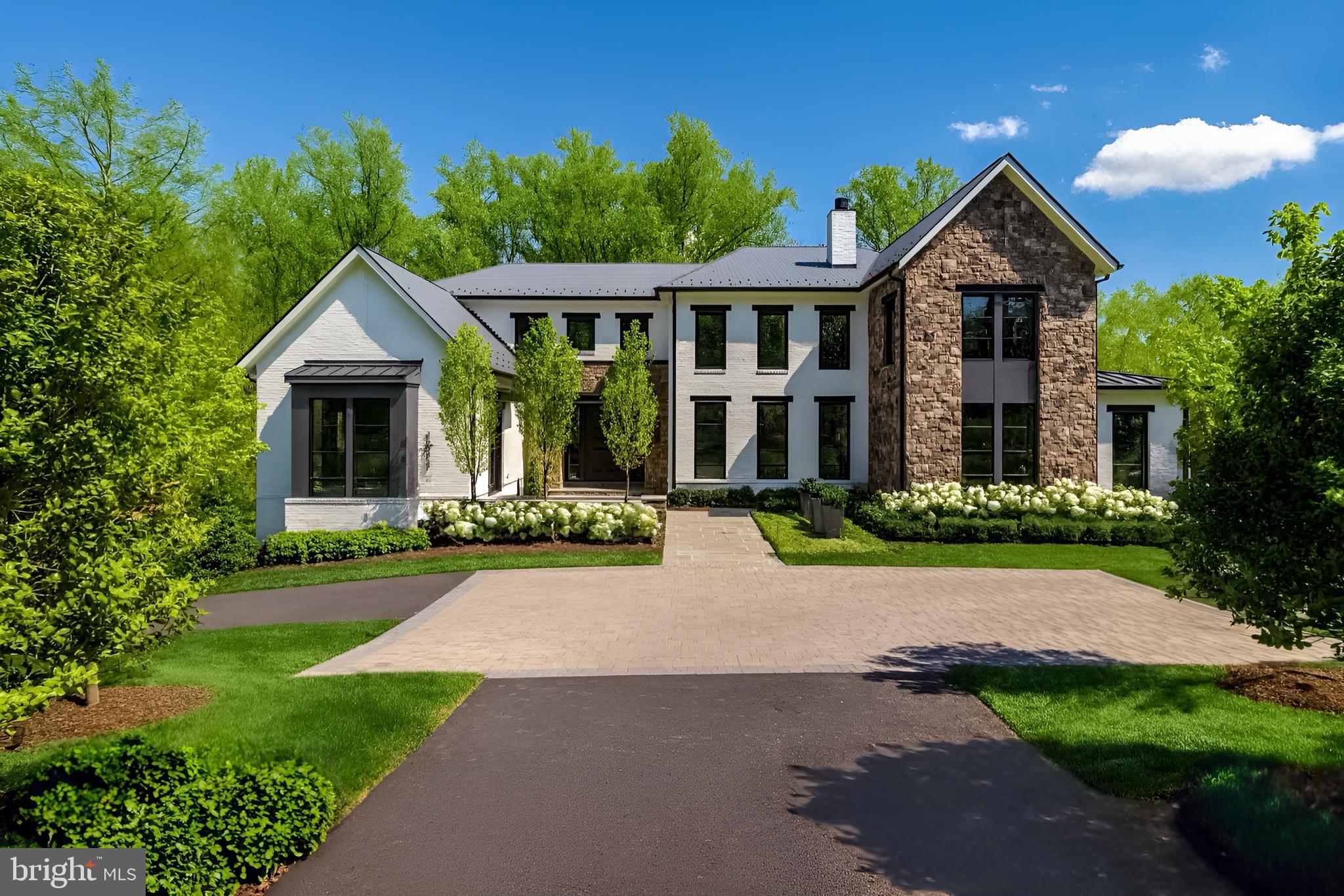 Breathtaking estate by Artisan Builders, located on a quiet cul-de-sac off prestigious Turkey Run Road in Langley Farms—McLean's preferred address. Backing to over 500 acres of pristine parkland, this private lot offers an unrivaled sense of seclusion and serenity. The stunning grounds, designed by award-winning landscape architect Charles Owens, include a sparkling pool, an outdoor kitchen, a cozy fire pit, and meticulously manicured spaces perfect for entertaining or serene relaxation. Upon entering, the foyer opens to the formal living room with a stately fireplace and a sunlit great room framed by expansive windows that offer sweeping views of the backyard oasis. The chef’s kitchen is a masterpiece, featuring top-of-the-line appliances, custom cabinetry, dual center islands, and a charming morning room. The main level also includes an elegant office and a well-appointed mudroom with a convenient and stylish built in dog crate. Upstairs, the luxurious owner’s suite is a sanctuary, complete with two spacious walk-in closets and a spa-inspired bath offering dual vanities and refined finishes. An additional family room, three en-suite bedrooms, and a dedicated laundry room complete the upper level. The lower level is designed for entertainment and wellness, boasting a large recreation room, a sleek wet bar, a state-of-the-art glass-enclosed fitness room, an additional bedroom with a full bath, and ample storage. Step outside to the covered terrace, accented with elegant ironwork, which overlooks the peaceful pool and verdant surroundings—a true retreat from the everyday. With a five-car garage and every detail thoughtfully curated this remarkable residence combines refined style and modern comfort making it the perfect retreat.