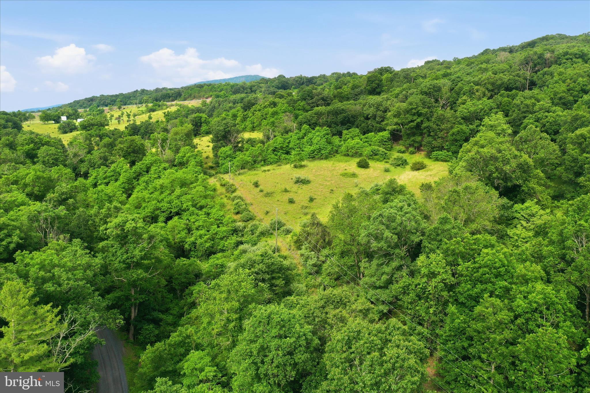 11.95± unrestricted acres located along Luxemburg Road in scenic Baker, West Virginia. This beautiful rural tract  provides an excellent setting for a private residence, weekend retreat, recreational property, or small farm.  

The property features road frontage for convenient access and enjoys the peaceful atmosphere of Hardy County while remaining within minutes of Corridor H, you can venture to Moorefield and other area amenities. 

With ample space for building, outdoor recreation, hunting, gardening, or livestock, this parcel presents an excellent opportunity to own a manageable acreage in the mountains of eastern West Virginia. Enjoy country living, panoramic views, abundant wildlife, and the privacy that comes with owning your own piece of Appalachian countryside.