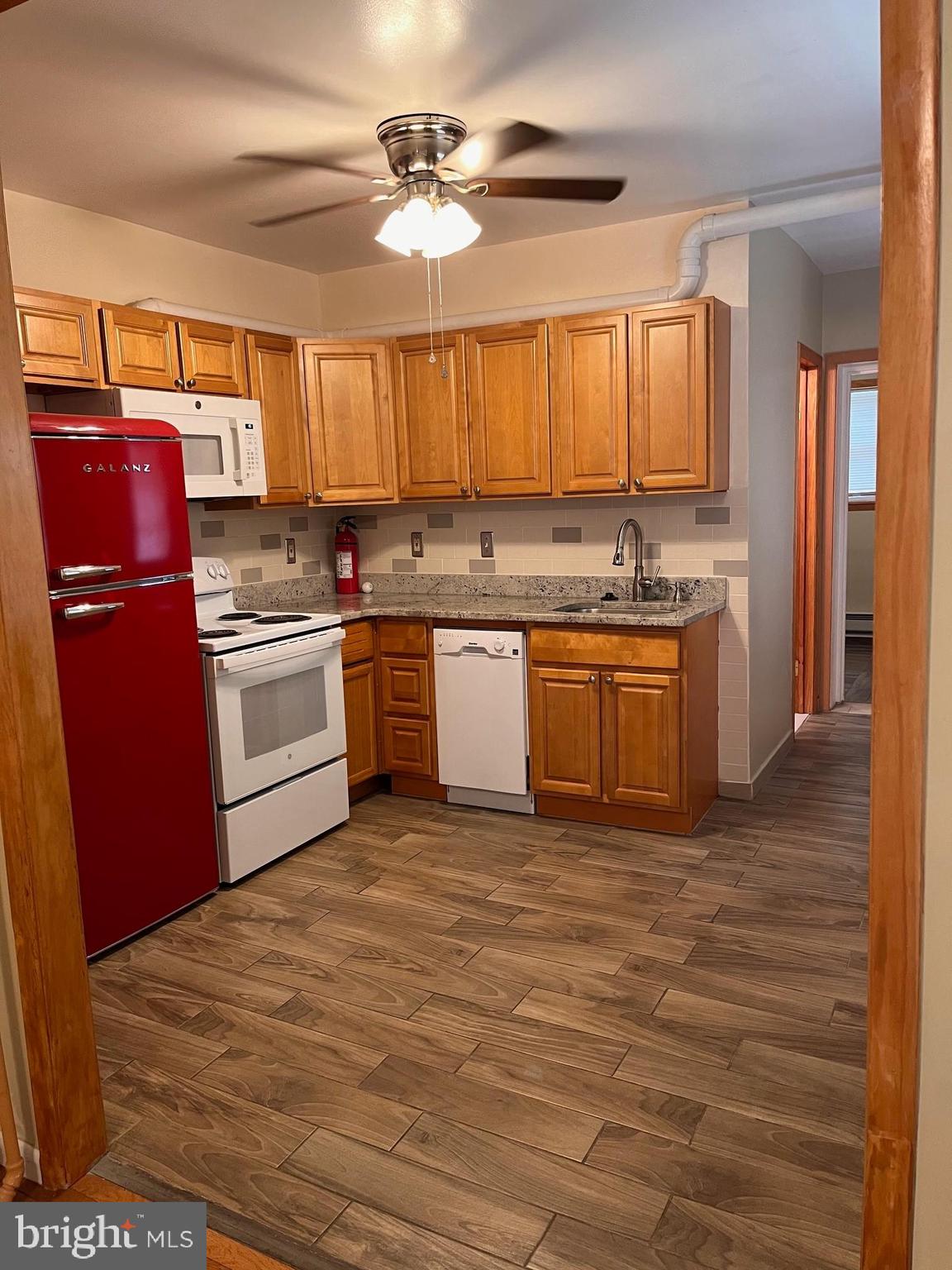 Enter through a tiled foyer with Olde City charm and high ceilings into a spacious 2 bedroom, 1 bath apartment with hardwood floors, high ceilings, ceiling fans and air conditioning.  The highlight of the kitchen is a retro-look refrigerator plus tile back splash and newer counter tops! Cozy living room with ceiling fan.  Modern, remodeled bathroom with tile shower and pedestal sink. All electric utilities.  You also have access to your own private, fenced back yard and basement with extra large storage and laundry.  Approximately 1100 square feet of space. Vibrant, residential neighborhood.  (Small "park" with benches less than a city block away)  Also convenient to the city's recently launched retro 15 trolley and the SEPTA elevated as well as the Girard Avenue shopping corridor which includes a grocery store and pharmacy, and dining in historic Fishtown.  NO smoking.  Cats okay.