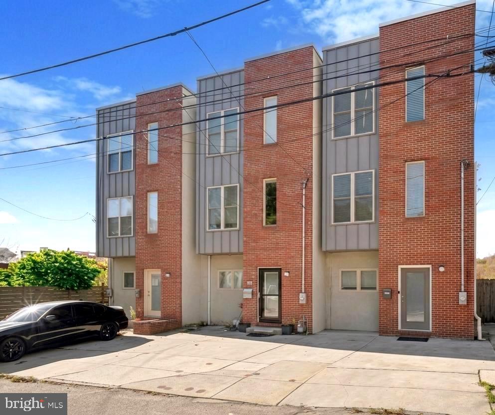 Welcome to 4128 Apple Street, an exceptional end-unit townhome in the heart of Manayunk featuring a private two-car driveway — one of the single rarest features in the neighborhood, where off-street parking for two vehicles is nearly impossible to find. With over 2,300 square feet across four fully finished levels, built in 2010 and significantly upgraded since, this home delivers condition and quality rarely found at this price point. This home is also free of any HOA fees, and with the seller offering a $2,500 credit at closing — apply it toward an interest rate buy-down or closing costs — this is an ownership opportunity as practical as it is impressive.

The walk-out lower level sets this home apart immediately, featuring brand new flooring, a custom wet bar, a newly renovated full bathroom with a tiled walk-in shower and modern vanity, and direct walk-out access to a private, flat courtyard perfect for year-round entertaining. This level works equally well as a guest suite, in-law accommodation, or entertainment space. The main level offers an open-concept living and dining area with real hardwood floors and 9-foot ceilings. The kitchen features granite countertops, a stainless steel appliance package, tile backsplash, a new under-mount Moen sink, and a pantry, with a private balcony just off the kitchen perfect for morning coffee or evening grilling.

The second floor delivers two generously sized bedrooms with ample closet space, a convenient laundry closet, and a refreshed shared full bathroom with modern fixtures and a neutral tile palette. The third-floor primary suite is a true retreat with a custom walk-in closet, a spa-inspired en-suite bathroom with a stone-floor walk-in shower, and a private terrace that leads up to the crown jewel of the home — the rooftop deck — offering sweeping 360-degree views of Manayunk and the Center City skyline with enough space to host a crowd.

Mechanical upgrades include a Lennox HVAC system, Bradford White hot water heater, smart Honeywell thermostat, and a radon remediation system — substantive investments that deliver real peace of mind. No HOA fees. No shared walls on one side. A private two-car driveway. All within a five-minute walk to Main Street and 20 minutes to Center City via regional rail. Listed at $538,900 with a seller-offered $2,500 closing credit — 4128 Apple Street delivers everything Manayunk buyers are looking for — come see it for yourself!