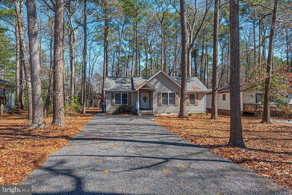 Nestled in the desirable community of Ocean Pines, MD, this recently renovated 3-bedroom, 2-bath home offers comfort, style, and a serene setting. The home features cathedral ceilings and a bright open floor plan with a split-bedroom design that provides added privacy. The gourmet kitchen is a standout with stainless steel appliances, upgraded countertops, a farmhouse sink, and an oversized breakfast bar—perfect for casual dining or entertaining. The sunny great room is filled with natural light and showcases new luxury vinyl plank flooring along with sliding glass doors that lead to an expansive screened porch overlooking a peaceful, wooded setting. Additional highlights include an outdoor storage shed, an extra-long driveway for ample parking, and a newer roof. This move-in ready home is ideal for enjoying the upcoming summer season. Furnishings are negotiable, making this a fantastic opportunity for a turnkey coastal retreat or year-round residence. Enjoy all the amenities of Ocean Pines now and this summer season. Home is priced to sell quickly so call now for your private showing