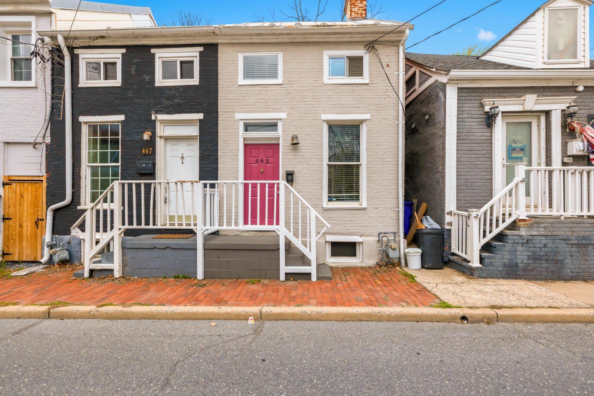 Charming and well-located 2-bedroom rowhome in downtown Frederick offering a rare combination of comfortable living and private off-street parking for the home, along with 9 garage units and 13 parking spots - making this a rare find with exceptional income-generating potential. The home underwent a full renovation in 2019, including addition of an HVAC system, and has been well maintained, including recent exterior and interior painting. It has a history of successful use as both a short-term and long-term rental. One full bathroom is on the main level, with an additional toilet in basement (often found in pre-WWII homes, this historic property was built in 1860!).

A standout feature is the extensive on-site parking infrastructure. The property includes private off-street parking for two vehicles directly behind the home, providing convenient residential access. In addition, the rear lot offers 13 rentable parking spaces and 9 garage units, creating significant flexibility and utility not commonly found in the area.

Substantial improvements were completed in 2022, including structural shoring and stabilization of all garage units to ensure long-term integrity. The entire lot was re-graded, leveled, and re-gravelled, and surrounding trees were trimmed back to improve access, usability, and safety. In 2024, the garage roof was treated with protective tar coating to extend durability. All garages are equipped with electric service (metered separately from house), and the property is further enhanced with installed security cameras.

A rare opportunity to own a residential property with substantial on-site parking capacity, storage, and income-producing potential in a highly desirable Frederick location.

Leases available upon request. The main residence will be delivered vacant after May 31st, providing an ideal opportunity for owner-occupants or new market-rate tenants. Existing garage and parking leases offer immediate cash flow with the flexibility for the new owner to retain or terminate.

Residential zoning. Buyer advised to perform due diligence regarding all building and development potential.
