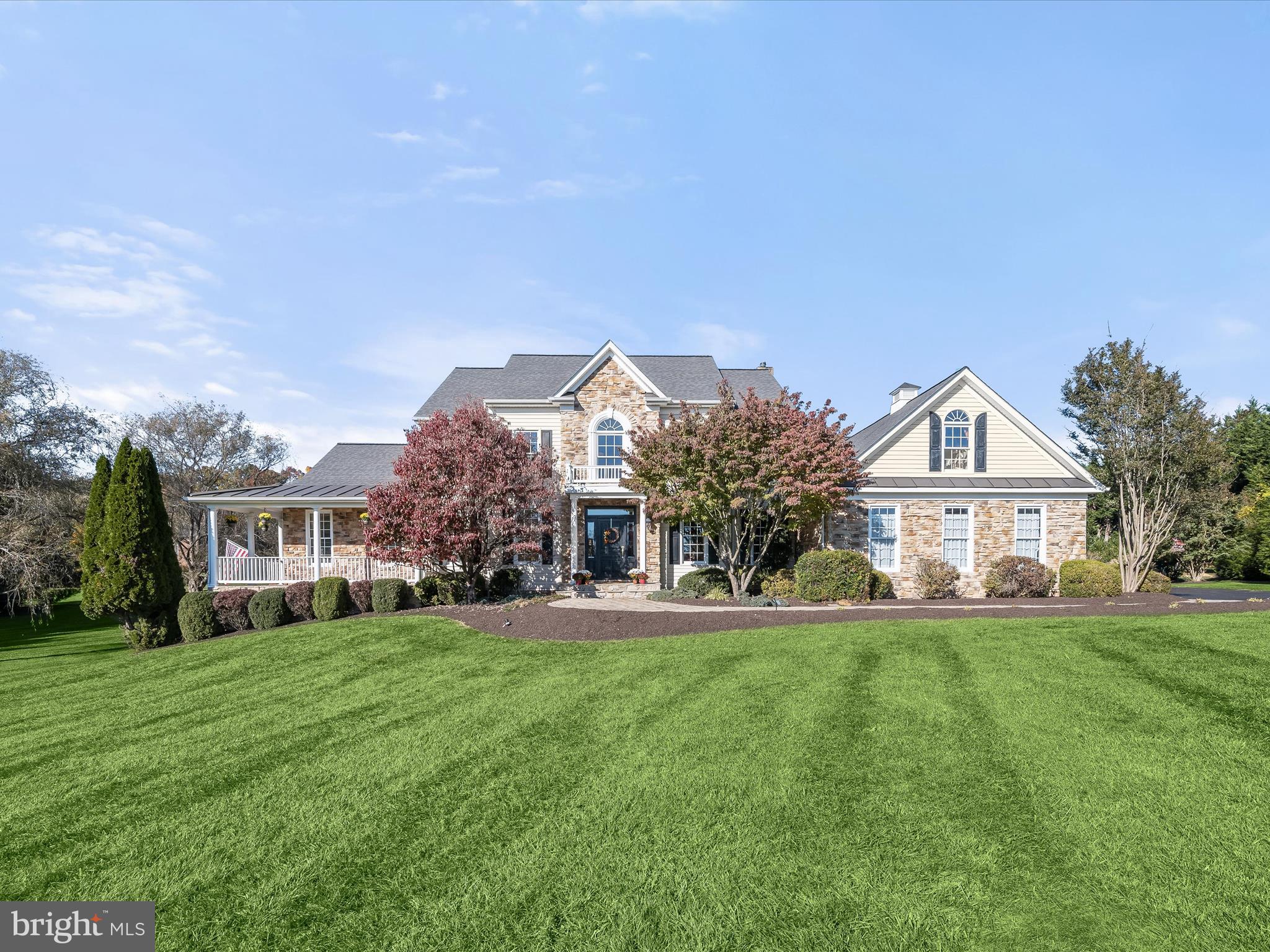 Nestled on over 2 acres of lush green grounds in the prestigious Wellington area of Glenwood, this home invites indoor and outdoor living and entertaining venues large and small. Outside, extensive paver walks escort guests to a covered stone front porch or a secondary side porch that welcomes family and friends. A hallmark wrap-around stone front porch in front, and a low-maintenance wrap-around rear deck, hot tub and screened porch overlook a glistening, heated in-ground pool with waterfall and spa. 

Perfectly designed for robust living and entertaining, this majestic setting offers resort-styled outdoor amenities and interior spaces to accommodate lifestyle, flexibility and comfort.  Inside, gleaming hardwood floors adorn the foyer, formal dining room, private study, and family room. 
The open plan design showcases a gourmet kitchen with a commanding entertainer’s island at center, and a Wolf gas cooking station and range hood for the chef of the house. Plate your creations and dine formally in the dining room, casually in the breakfast nook, screened porch, or dine alfresco on the deck or poolside under the pavilion. 

A primary bedroom and completely updated luxury bath suite are privately located in a wing on the main level with private access to the wrap around side and rear deck and hot tub.  Special moments on the main level also include an open plan family room with a cozy stone fireplace, a sunroom with a vaulted ceiling and windows where light streams in to brighten each day. Relaxing days poolside, and action-packed fun days splashing in pool are low maintenance with easy access to a newly upgraded side entry mud room and laundry center where pool linens can be easily laundered. From the main level, there is also a secondary stair from the kitchen to the upper-level landing, adding private accessibility to four more secondary bedrooms, served by two adjoining dual entry J & J baths, and a private vanity for each bedroom.

Downstairs, a finished lower level features a recreation room with full daylight and a walk out slider door leading to a covered patio, and paver walk to the rear lawn, pool and pavilion. Guests will also enjoy a festive beverage from the wet bar, or wine room, and a game of pool in the adjacent billiards room. The lower level is completed by a dual entry full bath and private guest quarters. 

Come home and decompress in the fold of extraordinary outdoor living spaces, lush, expansive grounds, mature trees and luxury interiors offering lifestyle options, flexibility and special moments at every turn!