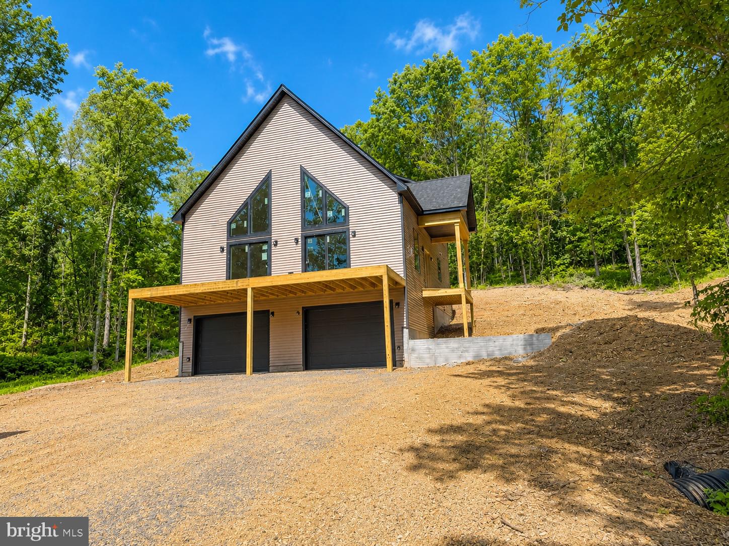 Featuring a 2-car detached garage and over 3 private wooded acres set the stage for this beautifully crafted new construction chalet, offering the perfect blend of modern comfort and peaceful seclusion. Thoughtfully designed for both everyday living and weekend escapes, this home features a functional floor plan with inviting living spaces throughout.
The upper level offers two spacious bedrooms and a full bathroom, creating a comfortable retreat with serene wooded views. The main level features the primary suite with a private bathroom, along with an additional half bath for guests and everyday convenience.
The heart of the home is the well-appointed kitchen, complete with granite countertops, ample cabinetry, and a full four-piece stainless steel appliance package—ideal for entertaining or preparing family meals.
The finished basement expands the living space with a spacious recreation room, an additional half bathroom, and plenty of storage or future expansion possibilities.
Surrounded by nature, this exceptional property offers the privacy and tranquility you've been searching for while providing all the benefits of quality new construction. Don't miss the opportunity to make this stunning chalet your own.