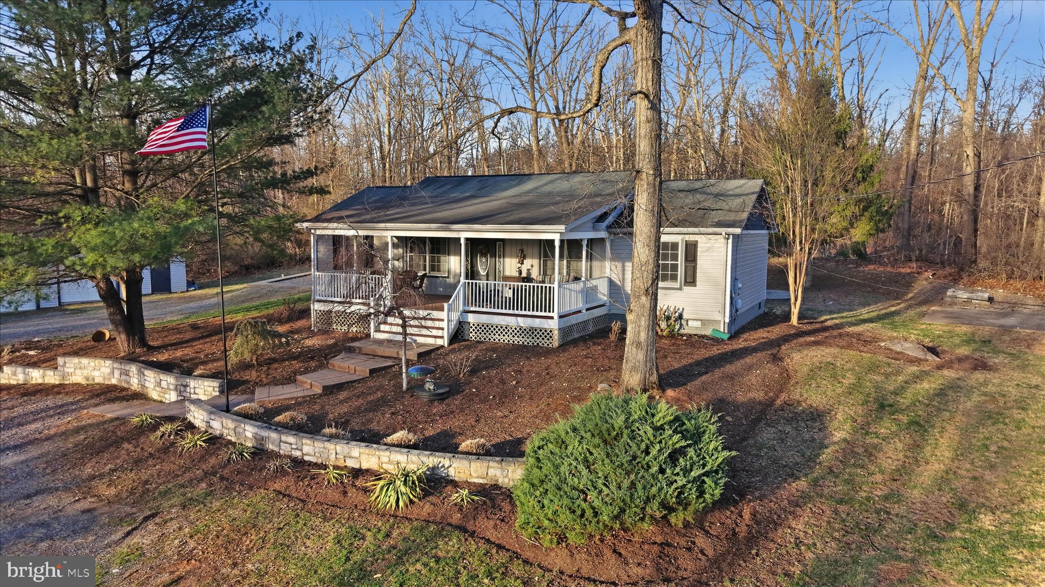 $10,000 PRICE REDUCTION!!! Come home to your private unrestricted 5 acre oasis!! Enjoy the 4 wheeler out on established trails, take target practice or just stroll thru the woods, your options are endless. Serene yet convenient location, less than 1.5 miles to I-81 and 10 minutes to shopping and restaurants. 4 bedroom, 2.5 bath rancher with spectacular, open and bright 33' X 33' addition which includes modern gourmet kitchen, stone fireplace with mantel (set up for gas or wood pellets), half bath and great room.  Primary suite and all bathrooms renovated, 2 detached garages (one 24' X 24', other 24' X 40' with office) with oversized doors and separate electric services and a large covered front porch with ceiling fans are among the many desirable features you will find. All new carpet in bedrooms, new refrigerator (with 2 icemakers!!), refreshed floor insulation and recently pumped and inspected septic. Priced less than January, 2025 appraisal, the owners' pride in this home is evident. Schedule your showing today!!.