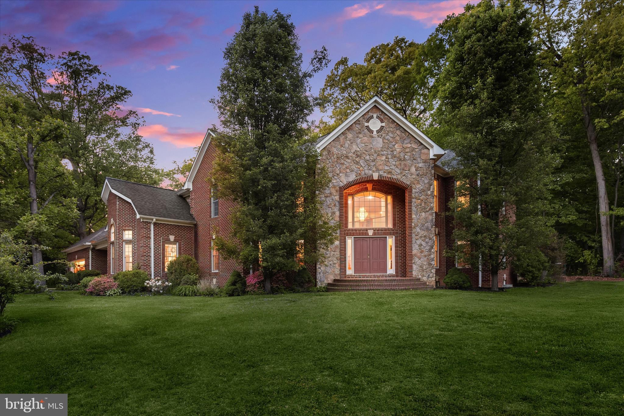 Set on a premium 1.61-acre lot, this exceptional brick estate delivers a true retreat lifestyle with a private backyard oasis and Caribbean swimming pool. Offering more than 7,400 square feet of refined, finished living space, the home blends timeless elegance with luxurious comfort.  A grand two-story foyer with travertine tile flooring opens to the formal dining room and an impressive great room anchored by a dramatic two-story stone fireplace, with seamless access to the pool and outdoor living areas. The gourmet kitchen is designed for both everyday living and entertaining, featuring an oversized island, granite countertops, top-tier stainless steel appliances, and a bay window breakfast room filled with natural light. A convenient side entry leads to the mudroom, laundry room, and oversized two-car garage.  The main-level primary suite serves as a private sanctuary, complete with a sitting room, two walk-in closets, and a spa-inspired bath with soaking tub, dual vanities, and a walk-in shower. A private home office adjacent to a half bath completes the main level.  Upstairs, an open overlook to the main living area enhances the home’s airy design. A second primary suite with potential for a private balcony, two additional bedrooms, a hall bath, and a second-floor laundry provide exceptional flexibility and comfort.  The expansive lower level, with rough-in plumbing already in place, offers endless possibilities for customization to suit your lifestyle.  Outdoors, lush landscaping and mature trees create a serene, private setting ideal for relaxation and entertaining. Ideally located near major commuter routes, shopping, dining, and entertainment, this remarkable property also benefits from no association fee.