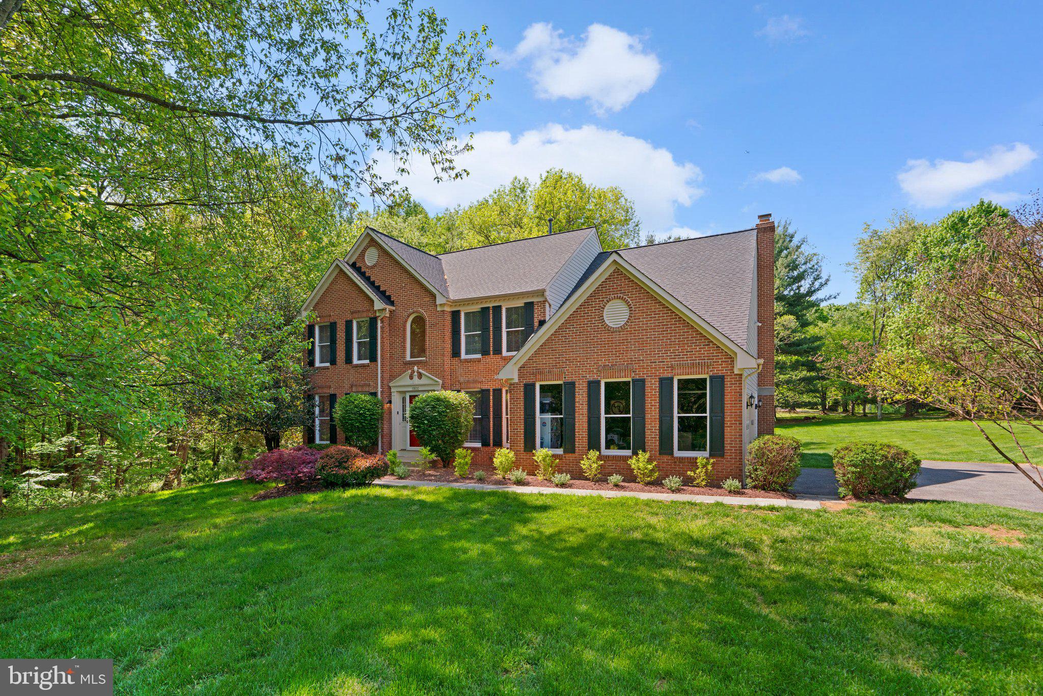 Welcome to this beautiful colonial home nestled on a tranquil, wooded lot backing to Rock Creek Park. This spacious 4-bedroom, 3.5-bath home combines timeless architectural character with modern comfort and functionality—ideal for both everyday living and elegant entertaining. Step into the grand two-story foyer, where gorgeous hardwood floors stretch throughout the main level, complemented by floor-to-ceiling windows that flood the home with natural light. The main floor offers a formal living room and dining room, perfect for hosting, as well as a dedicated home office for added convenience. The chef’s kitchen is truly the heart of the home—featuring abundant counter space, an island with bar seating, updated appliances, a pantry, and an eat-in breakfast area with access to the spacious back deck. The kitchen flows effortlessly into the warm and inviting family room with a cozy fireplace, which leads through double doors to a stunning four-season sunroom, also with deck access—ideal for indoor-outdoor living. A mudroom with laundry, connected to the 2-car garage, adds daily convenience, along with an updated powder room. The finished walk-out basement offers exceptional flexibility with brand-new carpet, a full bathroom, an expansive recreation area, generous storage, and access to a lower-level patio—an ideal space for entertaining or relaxing. Upstairs, you'll find four spacious and light-filled bedrooms, each with large windows and generous closet space, offering comfort and versatility for family, guests, or additional work/play space. The hall bath features a double vanity, perfect for busy mornings. The primary suite is a true showstopper—an inviting sanctuary with dramatic vaulted ceilings, sun-drenched windows, and ample space to unwind. The en suite bath offers a luxurious soaking tub, separate vanities, and a massive walk-in closet, creating a spa-like experience right at home. Outside, enjoy the home’s expansive backyard oasis—perfect for entertaining, relaxing, or enjoying outdoor activities. With direct access to nature, a peaceful setting, and a flowing, functional layout, this home offers the best of suburban tranquility and stylish living.