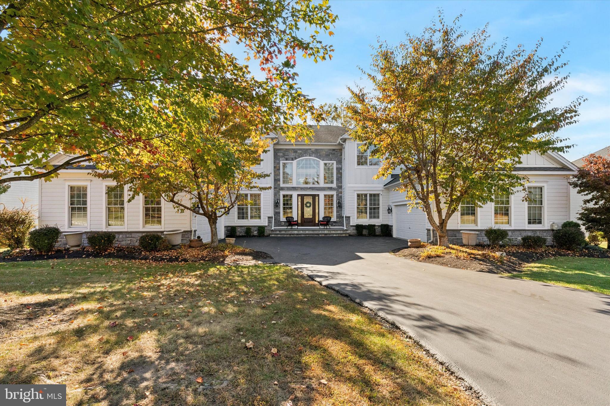 Back on the market due to buyers backing out  for personal reasons. Welcome to 1476 East Stonington Drive located in the highly sought after community, The Reserve at Chestnut Ridge and award-winning Downingtown school district. This luxurious home offers beautiful curb appeal with its stately front porch, court yard garages, mature trees and shrubbery. Make your way into the grand two-story foyer with hardwoods, a double spiral stair case with wainscotting, crown molding, sconces, a beautiful chandelier, palladium windows, and multiple coat closets.  Just off of the foyer you will find an au-pair suite/in-law suite with walk-in closet, a fully updated tiled bath with a Carrera marble floor, quartz vanity and subway tiled shower with custom inlay. Make your way back into the foyer with hardwoods that flow into the sun filled dining room with a 2-story ceiling, wainscotting, crown molding, picture window and recessed lighting. First floor features a large eat-in gourmet kitchen offering 42inch cabinetry with crown molding, under cabinet lighting, granite counters including a double stacked granite island with seating, tile back splash with a custom inlay design, stainless steel appliances, recessed lighting, crown molding, walk in pantry and breakfast area with access to the large private side trex deck perfect for entertaining. Just off of the kitchen you will find a large family room with a wood burning fireplace, recessed lighting, crown molding, built in surround sound speakers, picturesque windows and access to an additional private rear trex deck. Just down the hall is nice sized living room with wainscotting, crown molding and a large picture window. In addition, the first floor offers a private office/study with French doors, updated ½ bath with full wall custom backsplash, a first-floor laundry room and interior access to the tiled 2 car garage. Making your way up to the 2nd level you will find a lovely seating area with an abundance of natural light. 2nd floor features an elegant master suite with French doors, pillars, seating area, his and her double walk-in closets with built- ins, recently updated spa like bathroom with French doors, custom tile bath floor with in lay, soaking tub with tile surround, his and her granite vanity’s, make up station, stone back splash, crown molding, tiled shower with dual heads & custom inlay and a separate toilet room. Just down the hall you will find 3 additional nice sized bedrooms all with access to recently renovated full tiled bathrooms. Lower Level features a large entertaining area with recessed lights, chair rail, surround sound and walk out door to rear patio. In addition, you will find an amazing work out room with laminate hardwoods, recessed lighting, mirrors, built in speakers and a platform/stage. A large storage room with shelving completes the lower level.  Additionally, the 2nd two car garage can be accessed from the outside of the home. The rear yard which can be seen from both of your deck’s backs to a private wooded area with an abundance of wild life perfect for the nature lover.  This luxurious home has endured over 300K dollars in recent upgrades which include all new tiled bathrooms/fixtures/vanities, carpeting, updated kitchen counters/backsplash/appliances, updated fitness room, stucco removal, James Hardie board and batten siding/stone façade, limestone paver front porch, front door, several windows, both Heater/AC units and much more. Home is in close proximity to major routes, dinning, shopping and much more. Be sure to schedule your appointment today!