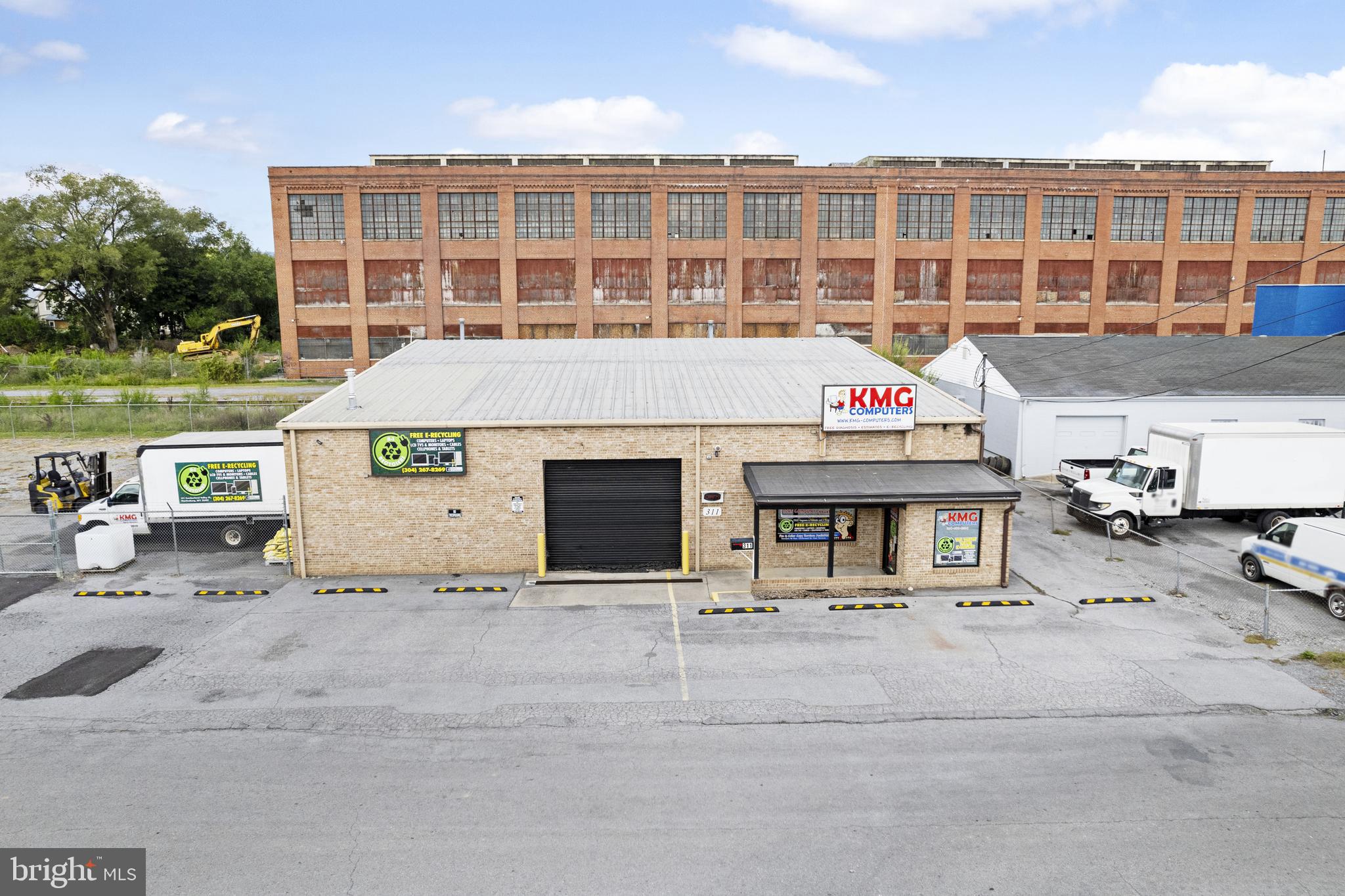 Owner financing acceptable with 50% down. 

Don’t miss this exceptional opportunity to own a versatile commercial property in the heart of downtown Martinsburg. This well-maintained building offers flexible space suitable for a wide range of business uses.

Upon entry, the front retail area features custom hand-built wooden shelving, display cases, abundant natural light from multiple windows, and a large interior window overlooking an attached office—ideal for visibility and functionality. Down the hall, you’ll find multiple private offices, a meeting room with sliding pocket doors, a customer half bath, and a separate employee half bath.

The property also includes a spacious upper-level loft currently used for storage, with existing heating and air conditioning already in place—making it a strong candidate for future finished space.

The warehouse portion of the building is equally impressive, featuring custom-built wooden shelving that conveys with the sale, along with two bay doors measuring approximately 12’ x 10’ and 14’ x 10’. Surrounding the warehouse is a secured, barbed-wire fenced area with a sliding gate, enclosing an approximately 7,200 square foot gravel lot—ideal for equipment storage, parking, or expansion.

Recent upgrades by the current owner include a new central heating and air system for the office/retail area, two new LG mini-splits and a gas heater in the warehouse, new carpet and vinyl flooring, a new roof over the foyer, two new hot water heaters, and a new stackable washer/dryer. The property also offers exterior electric, water, and sewer hookups suitable for RV use.

All square footage is estimated.
