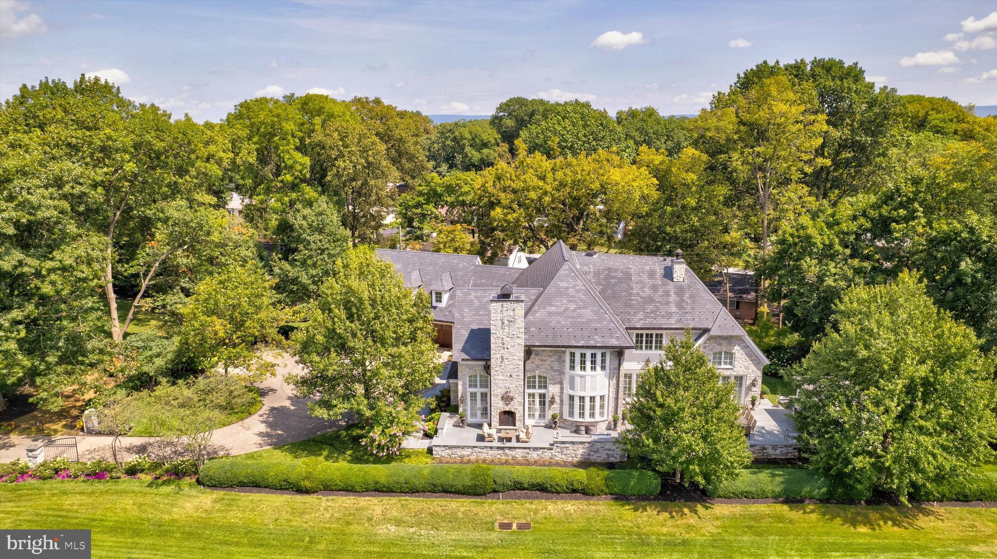 Welcome to your ultimate home or luxurious weekend getaway! Less than 50 miles from Washington, DC! This stunning estate on a pristine golf course offers unparalleled elegance and relaxation. With breathtaking views, sophisticated interiors, and top- notch amenities, this home is perfect for both entertainment and serene retreats. Imagine unwinding in your private oasis, surrounded by lush greens, or hosting memorable gatherings with friends and family. This is not just a home; it’s a lifestyle upgrade waiting for you!
This estate, spanning over 6,000 square feet, situated on the desirable Donald Ross golf course is more than just a home – it's an experience.
As you approach through the iron gates and long circular paver driveway, you will be amazed by the sight of this magnificent solid Fieldstone masterpiece.
Each handcrafted stone tells a tale of incredible workmanship, and the solid Mahagony front doors harmonize perfectly with the matching garage doors.
Step onto hand-hewn solid cherry hardwood floors, ingeniously heated, providing both warmth and luxury underfoot. Every corner exudes craftsmanship, with Petersheim cabinetry and intricate moldings setting the tone.
The living room, embellished with custom built-ins and solid wood doors, serves as the perfect gathering place. Three gas fireplaces throughout this beauty create intimate spaces, each with its own character and charm.
At the heart of this incredible home lies the ultimate gourmet kitchen, second to none... a cook's dream, where custom cabinetry some with leaded glass, a new maintenance-free soapstone island paired with granite countertops, multiple refrigeration systems, and top-tier appliances create a chef’s experience beyond compare.
Take the stairs or elevator to the upper level, where a private in-law suite awaits with its own mini-kitchen and living room. The upper level also houses a beautiful study and two guest suites that overlook the perfectly manicured grounds of the golf course.
The primary suite on the main level is a sanctuary in itself. Every element here is designed for rest, relaxation, and opulence.
But that's not all.  
Step into the office/library. This clean air filtered, climate-controlled workspace hosts wall-to-wall solid cherry built-ins and a secret temperature-controlled wine room that stands ready for your vintage collection. And yes, for the connoisseur, a humidor/gun closet lies discreetly tucked away.
Outside, experience alfresco luxury with a superior outdoor kitchen under a mahogany-ceilinged pergola. 2,000 square feet of outdoor entertainment space enables you to gather around the large gas fire pit. Among other high-end appointments is an oversized Viking Grill. The outdoor realm resonates with the flicker of one switch-all gas lighting. Revel in the beauty of natural fieldstone and exotic bluestone slate flooring from Brazil.
Every facet of luxury living has been meticulously curated in this residence. With the foresight of two 1,000-gallon propane tanks, you are guaranteed consistent, uninterrupted warmth on the chilliest of nights. And the luxury doesn't end there; imagine stepping into any bathroom or kitchen and instantly being greeted with hot water, a testament to the home's commitment to unparalleled convenience comfort and grandeur in every corner.
And for your vehicles, the attached heated, oversized three-car garage, with new mahogany doors and durable maintenance-free interlocking floor tiles ensures your chariots too are enveloped in luxury.
A 50-year slate-like rubber shingle crowns this home and symbolizes durability and sophistication. It's the detail, the artistry, and the luxury that sets this home apart. Adjacent lot available for additional price.