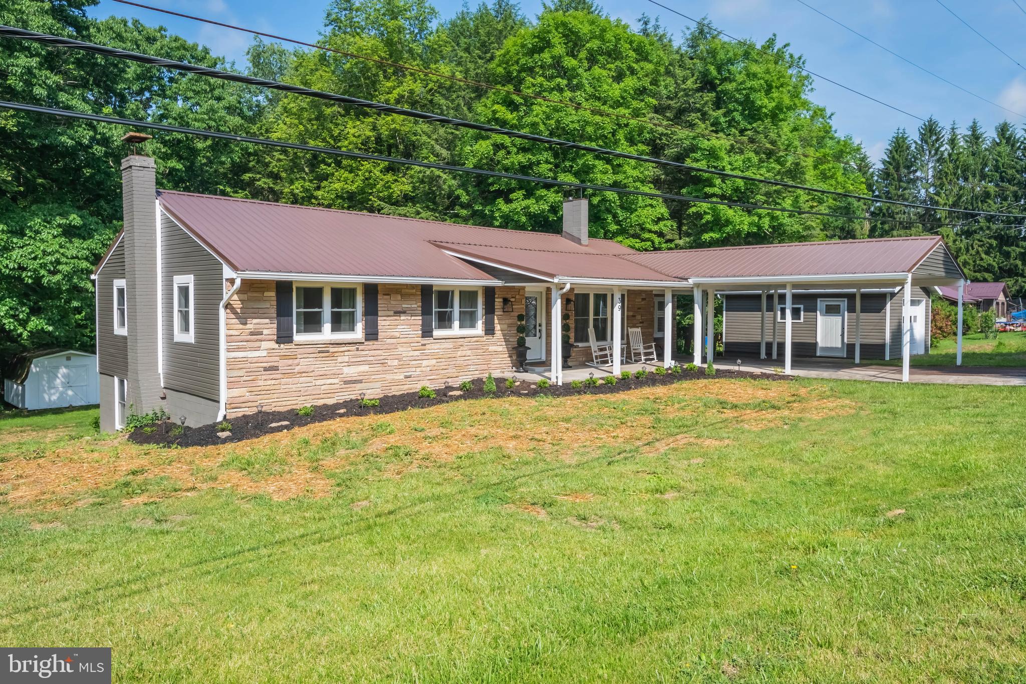 Beautifully remodeled from top to bottom, this move-in-ready stone rancher offers the perfect blend of modern updates and comfortable living. Step inside to find a completely refreshed interior featuring updated finishes throughout. Relax and enjoy the outdoors from the spacious covered front patio or entertain guests on the covered rear porch overlooking the backyard. A gentle stream along the rear of the property adds a peaceful, scenic touch and creates a tranquil setting to enjoy year-round. The lower level has been completely finished with a great stone electric fireplace. This space has endless possibilities. The thoughtful renovations make this home a must-see. Close to I-68 and all the wonderful amenities the town of Grantsville has to offer!