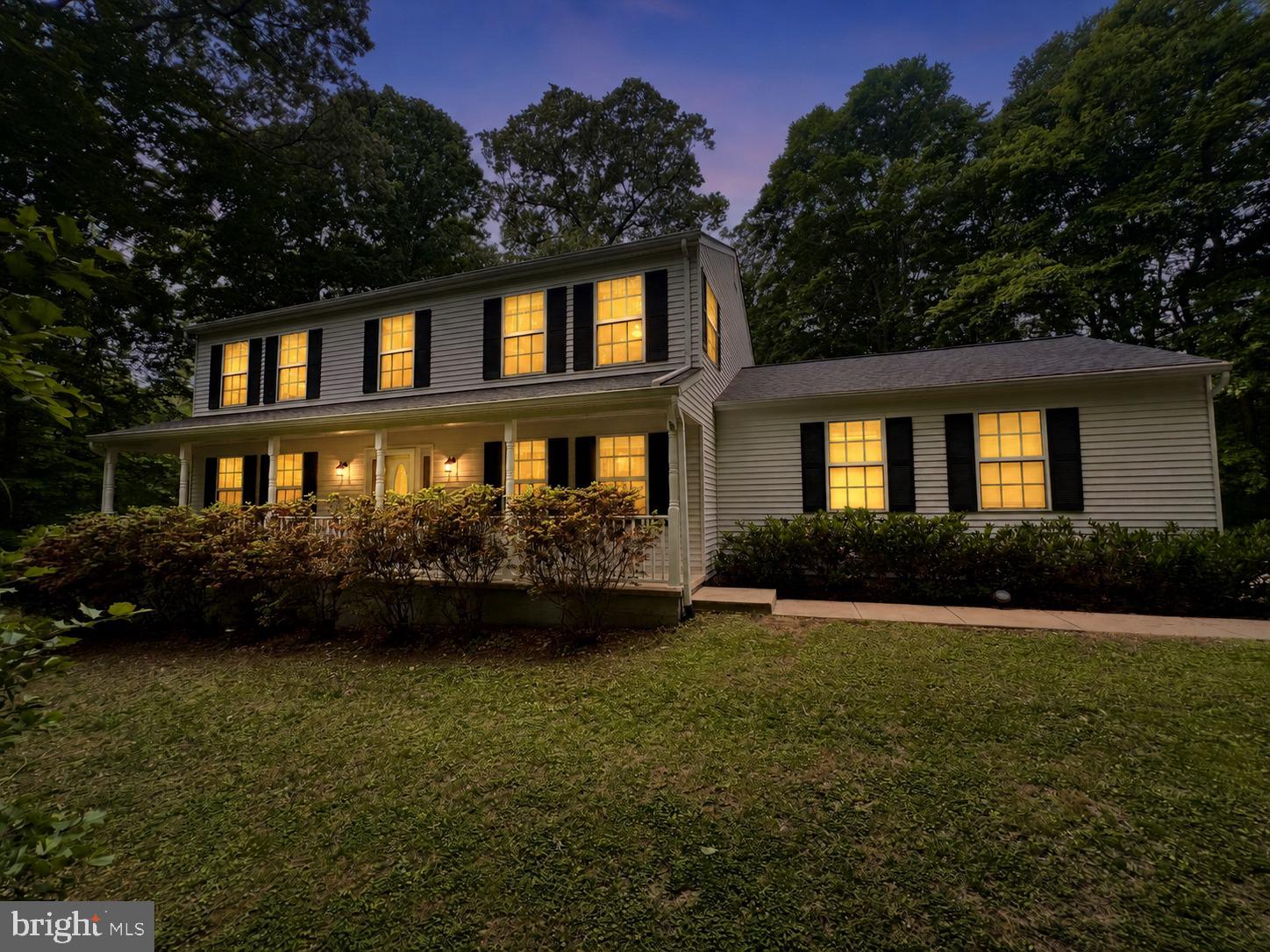 Tucked away on a picturesque 4-acre lot, this exceptional Northern Calvert retreat offers a rare blend of privacy, space, and convenience. Surrounded by mature trees, curated walking trails, and conservation land, 8200 Sycamore Circle delivers a peaceful, retreat-like setting while remaining ideally positioned near commuter routes, shopping, dining, and the Chesapeake Bay lifestyle.

Just 30 minutes from Joint Base Andrews and within an hour of Washington, D.C., the Pentagon, Annapolis, Fort Meade, PAX River, and Baltimore, this thoughtfully appointed property is perfectly suited for both everyday living and commuting convenience. The home is also equipped with electric vehicle charging capabilities, including two NEMA 14-50 outlets.

A timeless colonial design welcomes you with spacious living areas designed for both comfortable daily living and effortless entertaining. The main level features formal dining spaces, a wet bar with wine refrigerator, and seamless access to the expansive rear patio — creating the ideal backdrop for gatherings indoors and out. Beyond the home, the manicured grounds are accented by flowering landscaping and private trails that extend into the surrounding conservation land.

Upstairs, the private primary suite offers a serene retreat complete with an en-suite bath and oversized walk-in closet. Three additional bedrooms share a generously sized bath with dual vanities, while the conveniently located upper-level laundry room adds everyday practicality.

The partially finished lower level offers flexibility for a cozy den, office, fitness space, or future expansion. With a walkout to the backyard and substantial unfinished storage and utility space, the lower level provides endless opportunity to tailor the home to your needs.

Recent improvements include:
• New refrigerator and microwave (2026)
• New roof (2025)
• New well pump and water treatment system (2025)
• New HVAC system (2021)
• New sump pump (2021)

Whether hosting guests, enjoying the tranquility of the property, or exploring the surrounding natural beauty, this home offers the refined lifestyle today’s buyers are seeking.