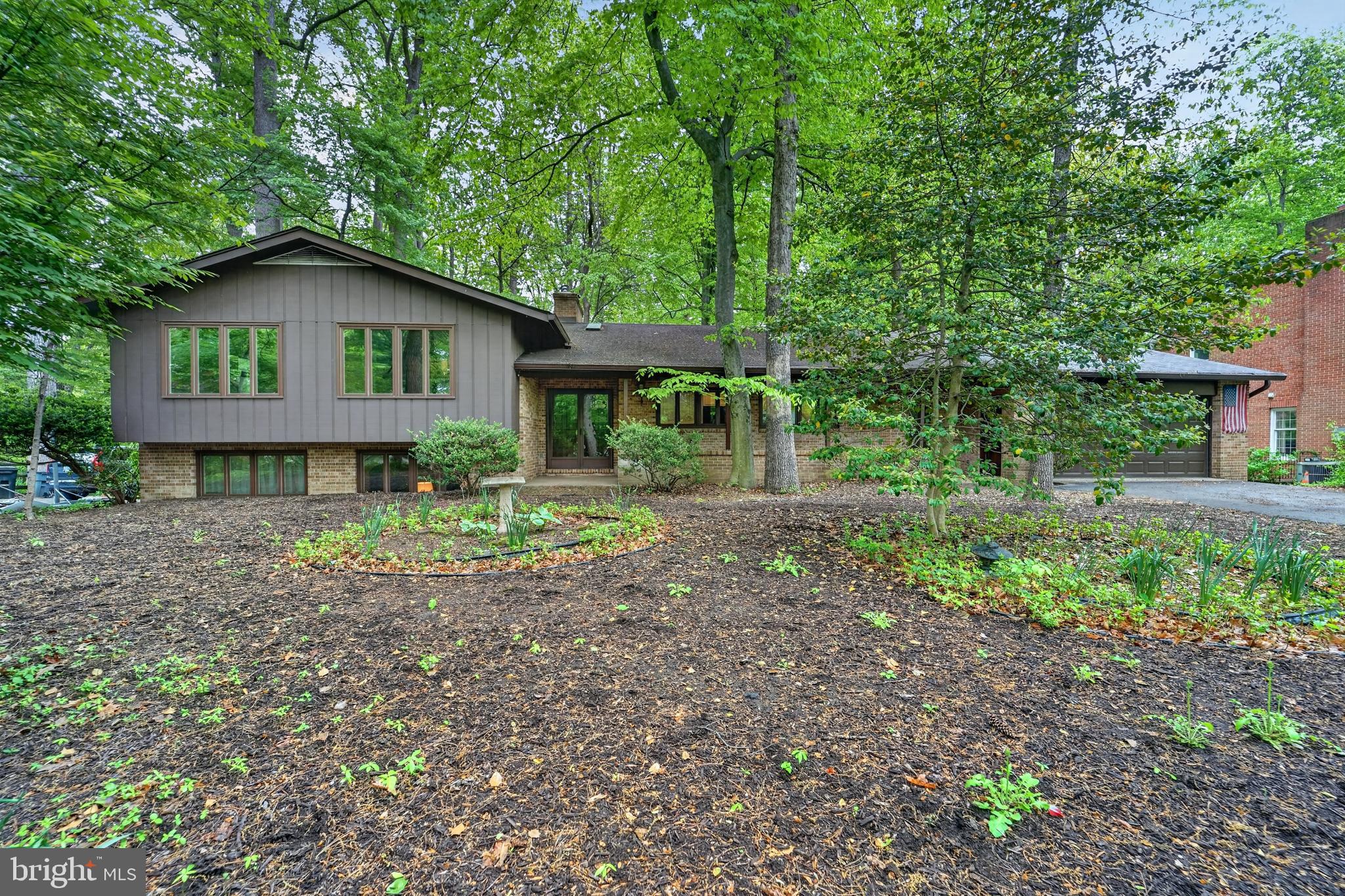 Opportunity awaits! Don’t miss out on this well-built and spacious brick home with an oversized two car garage perfectly situated on a half-acre lot in the desirable community of Longfellow, Harper’s Choice, Columbia. Tucked away toward the back of the neighborhood minutes from paved walking and biking trails and the vibrant Merriweather district, this home is convenient yet private. It boasts a total of 4,426 square feet of space with 3,390 being improved above grade and another 1,036 below for recreation, storage and utilities. Left of the main entry foyer, upon entering, you will find an updated and upgraded 239 sq ft kitchen with expansive stone counter tops and tons of functional cabinetry. Past the kitchen this stately home opens to a generously sized living room accentuated by a stunning floor to ceiling, windows and brick wall with wood burning fireplace. The spacious formal dining room overlooks its secluded backyard. After dinner, retire and relax in your own personal haven. A naturally heated sunroom supplemented by a cozy wood stove for colder months. A few steps up from the main level you will find the primary suite with en-suite bath as well as three large secondary bedrooms sharing a center hall bathroom. Open to, and just a few steps down from the main level, you and your family and friends will enjoy gathering in the large family room boasting a stylish retro bar and a second brick fireplace accented by a wall of windows and a sliding glass door leading to the fenced backyard. Off of the family room you will find two additional rooms which can be reimagined as offices, hobby or play spaces along with a half bath. The second lower level has even more space for recreation and storage, including a cedar closet, laundry and an additional workshop. Priced below market, this home is sturdy and ready to easily be refreshed! The roof was replaced in 2015 but the property is being offered as-is affording a rare opportunity to a savvy buyer! Columbia residents enjoy easy access and reduced fees to the association’s extensive amenities, including gyms, pools, parks, lakes, walking paths and other recreational facilities. Conveniently located almost mid-way between Baltimore and DC near a multitude of restaurants, shopping, top-rated schools, major commuter routes and the Baltimore Washington International Airport. Offering the perfect combination of location, space and opportunity. This home won't last long. Visit an open house or schedule an appointment to tour it ASAP!  Home has been well maintained but buyers may desire an update to finishings such as floors, walls and baths.