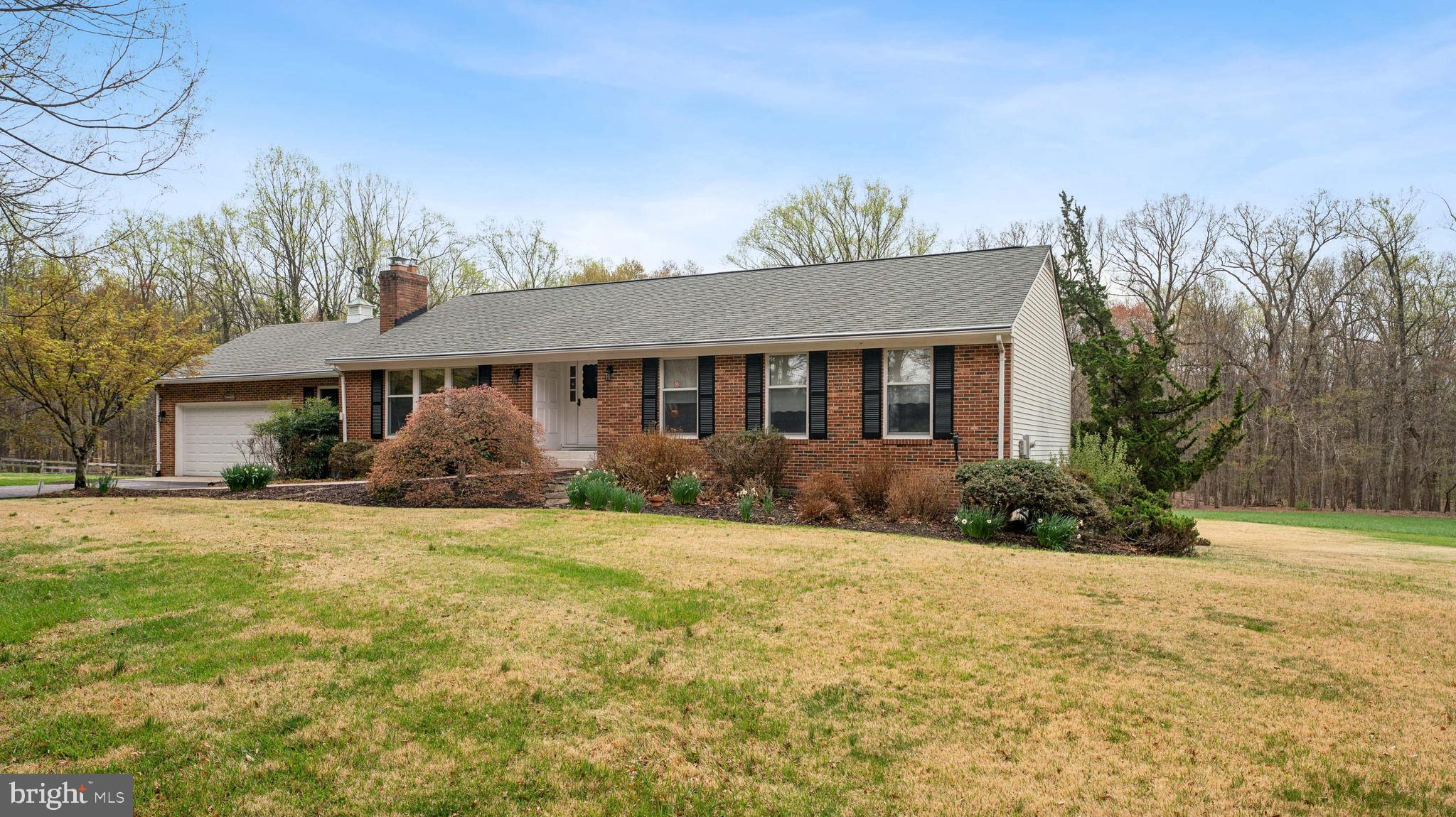 This Charming 4 Bedroom 3 Bath rancher is situated on a private & secluded 4.22 acreage parcel. Grab your favorite beverage   & take in the picturesque backyard view on the recently built TREX deck. Inside there's over 1500 sq. ft. of Main Level living space with an open living room & wood burning fireplace, a separate dining room, an eat-in kitchen w/updated appliances, a laundry room plus 3 bedrooms & 2 full baths! The spacious primary bedroom features a private bath with his/her sinks & a large clothes closet. The fully finished Lower Level features walk-out french style doors, a Large Rec Room, a 4th. Bedroom w/large closet & a Full Bath plus a Hot Tub & a Wood Burning Stove. Recent new HVAC & Water Heater! This property features an abundance of weed-free Zoysia grass known for it's great durability & drought tolerance. Where can you find a home  with 4+ acres in Howard County at this price?!
