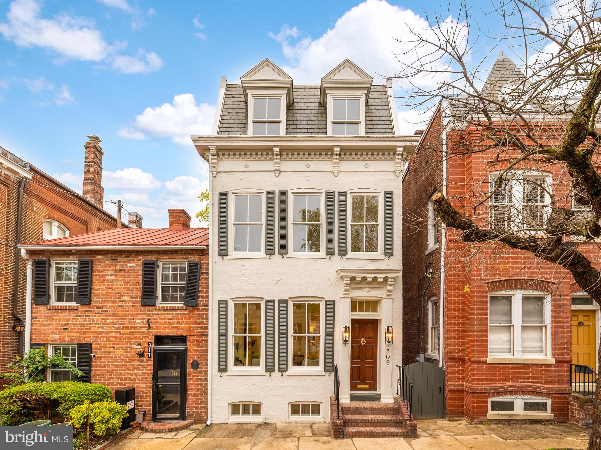 Welcome to 309 Duke Street, an exquisitely remodeled gem nestled in the heart of Old Town Alexandria. This stunning residence has been meticulously transformed by the renowned Summit Homes, with interior design by the talented Courtney Cox, ensuring every detail is both intentional and inspiring.

Boasting 2,100 square feet across four beautifully finished levels, this home offers three spacious bedrooms and three and a half luxurious bathrooms. A quintessential Old Town stoop welcomes you into the warm embrace of this light-filled abode. The main floor presents an inviting living/family room that seamlessly flows into a sophisticated dining area and a chef's dream kitchen.

The kitchen is a true masterpiece, featuring top-of-the-line Viking appliances, Taj Mahal Quartzite countertops, and exquisite Architessa tiles. The Zenit cabinets offer ample storage, complemented by a convenient pot filler. The main floor also hosts an adorable half bath, which is elevated by chic wallpaper and elegant gold fixtures, adding a touch of glamour to this functional space. The fully finished basement provides additional living space, perfect for a media room or a casual hangout area.

Ascend to the second level to discover two well-appointed bedrooms, each with ensuite bathrooms. The primary bathroom is a sanctuary of luxury, showcasing elegant Waterworks fixtures, while all the full bathrooms in the home boast the added comfort of heated floors. The guest bathroom on this level is equally impressive, featuring gorgeous earthy green tiles that create a serene, natural ambiance. The third level houses an additional bedroom and a meticulously designed bathroom, providing versatility and privacy for family or guests.

As you reach the pinnacle of the home, discover the jewel of 309 Duke Street—the expansive roof deck. This outdoor oasis offers endless opportunities to relax, entertain, and enjoy the serene surroundings of Old Town.

Situated a short stroll from the bustling waterfront, this home is perfectly located to enjoy all the shops, restaurants, and historic charm that King Street has to offer. Nearby amenities include the Armory Tot Lot, Windmill Hill Park, and convenient shopping at Safeway, Balducci's, and Trader Joe's. Experience the epitome of luxury and design excellence in this exceptional Old Town residence.