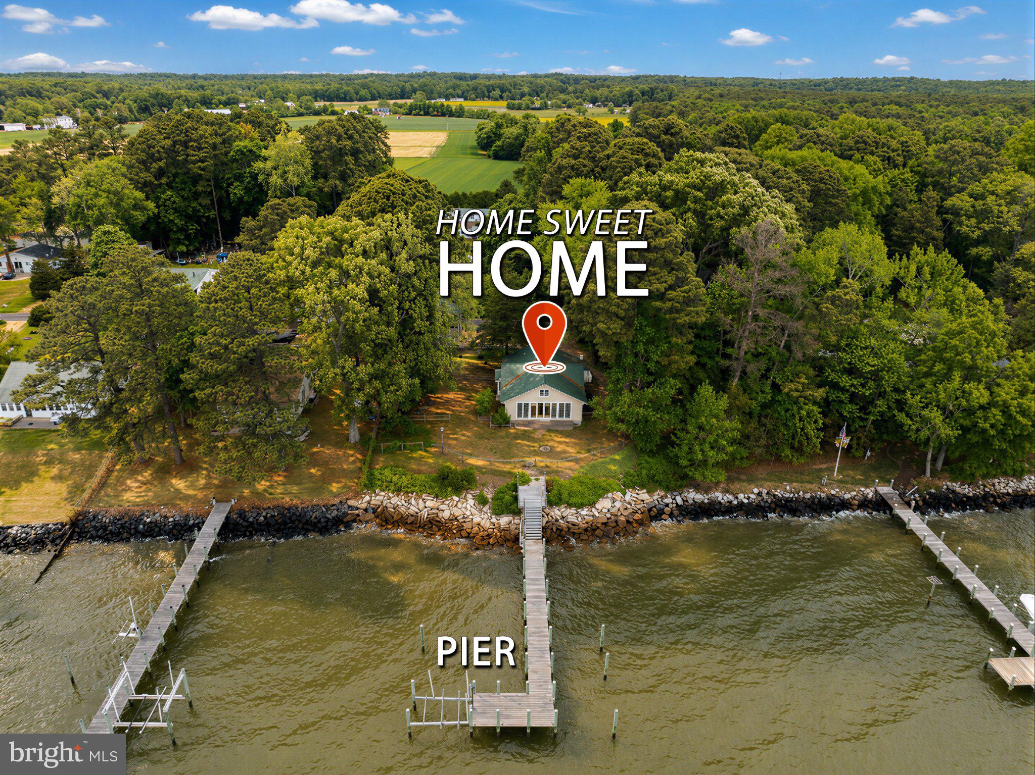 Enjoy peaceful mornings in the 11’ x 26’ sunroom with wall of windows offering unobstructed views of the Potomac River from Piney Point, Virginia shoreline and west to St. Clements Island. End your day with majestic sunsets. A perfect waterfront escape but minutes to Leonardtown! Vintage 1920’s Cottage with all mechanicals, roof, windows, doors updated within the last 10 years but still exhibiting original craftmanship and renovations throughout the years. Livable preserved charm but perfect for an updating to make it your own. Roomy kitchen opens to great room with 9 ft. beamed ceilings, bay window, and a brick fireplace with woodstove all open to expansive sunroom. Master bedroom with large bath with soaking tub, 6’ x 9’ walk in closet and even a bidet. Entrance foyer with laundry area. Second floor 15’ x 7’ loft perfect for extra sleep or rec room. Over 1,600 sq. ft. of finished area plus a newly constructed detached 480 sq. ft. 2 car garage with 2nd level partly finished coach house apartment and 6’ x 10’ covered porch with waterfront views.  Apartment is under roof, sided with electrical and plumbing rough-in with over 400 sq. ft. Fully permitted (that’s important). Combined square footage when completed will be over 2,000.  Coach House perfect for guests, family, or rental income. Over 100 feet of protected shoreline with 80 ft. pier plus 10’ x 20’ L platform, power boat lift and 1 slip. Nice sized 10 ‘x 21’ deck accessing pier on shoreline. Wooded lot at the end of a dead-end street!