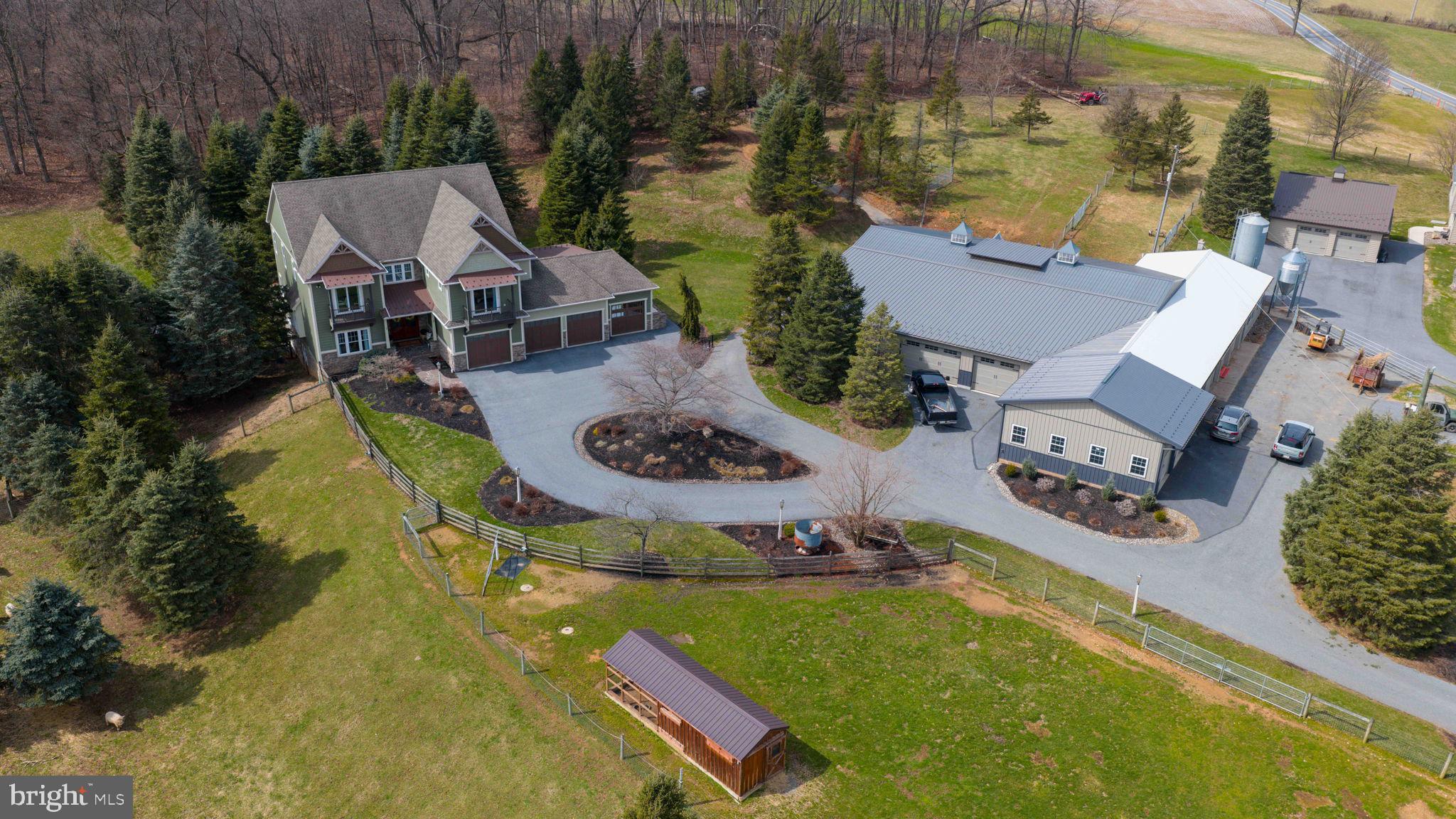 Private dual-residence estate combining luxury construction with fully developed agricultural infrastructure on 10+/- acres. --------------
This custom-built residence (2013) offers over 4,800 sq. ft. above grade with four bedrooms and five bathrooms, plus a finished lower level featuring an additional bedroom, living area, and 10’ ceilings. The home reflects estate-level construction with generous scale, quality materials, and thoughtful design throughout. Additional features include 9’x8’ overhead doors in the three-car attached garage, and a seamless connection to outdoor living anchored by a large flagstone patio with chimney hearth.
A second full residence provides three bedrooms, two bathrooms, and a two-car detached garage—ideal for multi-generational living, guest accommodations, or on-site management.
The property is exceptionally well-equipped for agricultural or commercial business use with an extensive multi-section barn and shop complex (approx. 7,800 sq.ft.) including: -----
30’ x 25’ garage/shop with (2) 8’x9’ overhead doors-----
29’ x 88’ shop / barn section with (3) 8’x9’ overhead doors-----
60’ x 55’ shop structure with (5) roll-up doors-----
21’ x 61’ shop section with (2) overhead doors (8’x14’ and 8’x10’)-----
Additional improvements include a large bank barn, multiple run-in sheds, fenced pastures, greenhouse, and chicken coop—supporting equestrian, livestock, or small-scale farm operations.-----
A standby propane generator system services both the main residence and shop, supported by two 1,000-gallon buried propane tanks, providing reliability and long-term utility.-----
A rare offering where custom residential quality, multi-dwelling flexibility, and turnkey agricultural/ commercial infrastructure converge—creating a property that would be difficult to replicate at today’s construction costs.