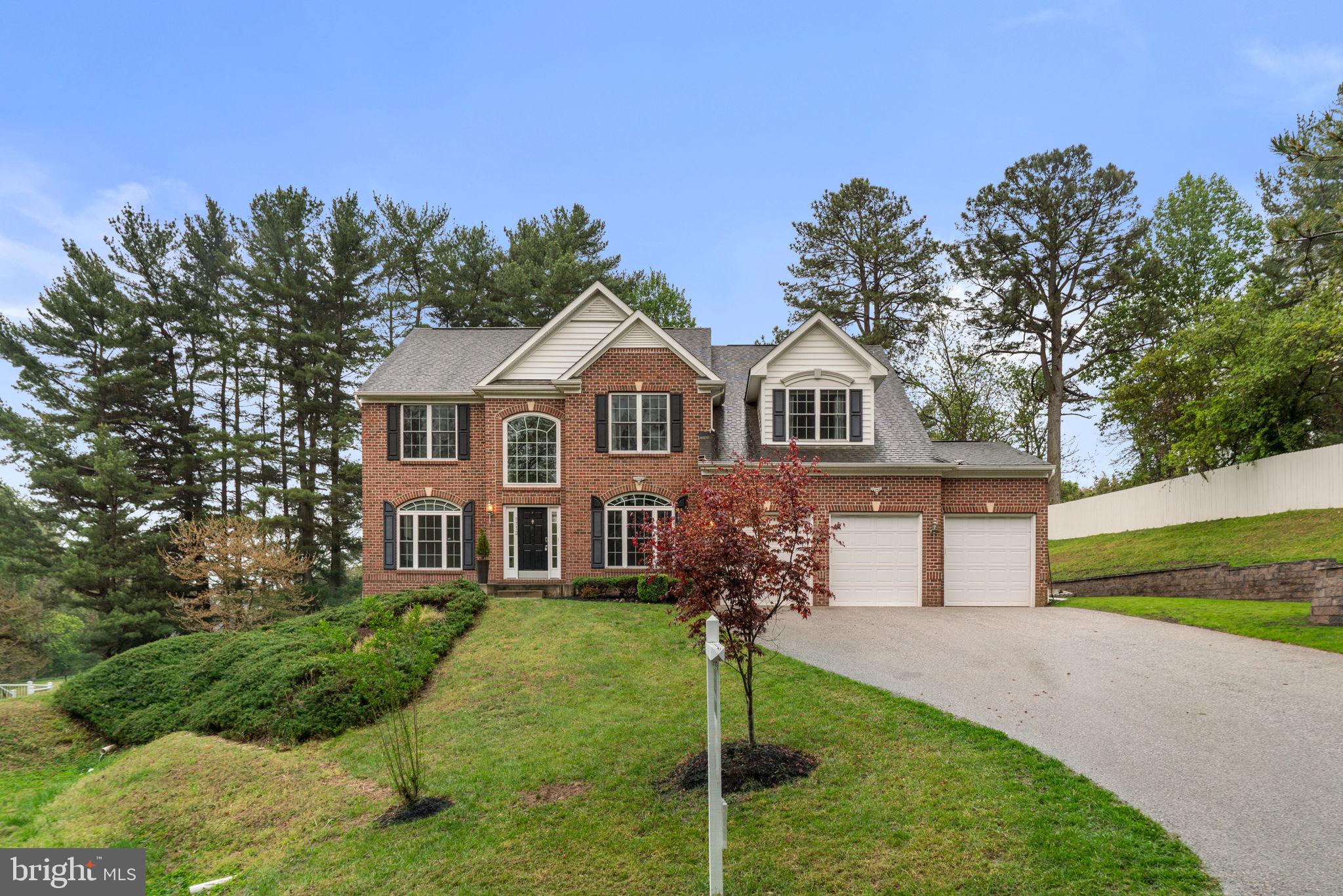 Set within one of Ellicott City’s most sought-after enclaves, this distinguished Colonial residence
presents a refined interpretation of luxury living, where timeless architecture meets a thoughtfully
curated, open-concept design. Expansive interiors are bathed in natural light and enhanced by graceful
columns, intricate crown molding, and elevated finishes that create a sense of quiet sophistication
throughout.
Rich hardwood flooring unfolds across the main level, beginning with a dramatic two-story foyer that
sets an elegant tone. The formal dining room is framed by architectural columns and elevated by a
contemporary built-in china display and bespoke wood-paneled accent walls, offering a striking setting
for memorable gatherings. Opposite, the formal living room, adorned with arched windows and refined
detailing, provides an intimate space for conversation and entertaining. At the heart of the home, the
grand two-story family room captivates with soaring ceilings, a gas fireplace, and a wall of upper arched
windows that fill the space with soft, natural light.
The gourmet kitchen is seamlessly integrated for both daily living and elevated hosting, featuring a
well-appointed butler’s pantry, custom cabinetry with glass-front accents, a generous center island,
stainless steel appliances, and a walk-in pantry. The adjoining breakfast area, with direct access to the
outdoors, enhances the home’s effortless flow. A private main-level bedroom suite with its own bath
offers ideal accommodations for guests or multigenerational living, complemented by a conveniently
located laundry room.
Upstairs, four spacious bedrooms and three full baths provide a balanced blend of comfort and privacy.
The primary suite is a true retreat, defined by cathedral ceilings, a serene sitting area, and a
custom-designed walk-in closet. The spa-inspired bath features a corner soaking tub, a separate
glass-enclosed shower, dual vanities, and a private water closet. Two secondary bedrooms share a
thoughtfully designed dual-entry bath, while an additional bedroom enjoys its own en-suite.
The walk-out lower level extends the home’s living space with a generous recreation area, a sixth
bedroom with a walk-in closet, a full bath, and versatile unfinished areas—including a dedicated space
with gym flooring, ideal for a private fitness studio or future customization.
Outdoors, the property unfolds into a beautifully landscaped setting designed for both relaxation and
entertaining. A custom paver patio with a curved retaining wall overlooks a spacious, level backyard
framed by mature pine trees, offering privacy and a tranquil backdrop. Multiple terraced areas provide
exceptional potential for a future pool, outdoor lounge, or play space, completing this exceptional
offering. Select photos feature virtual staging.