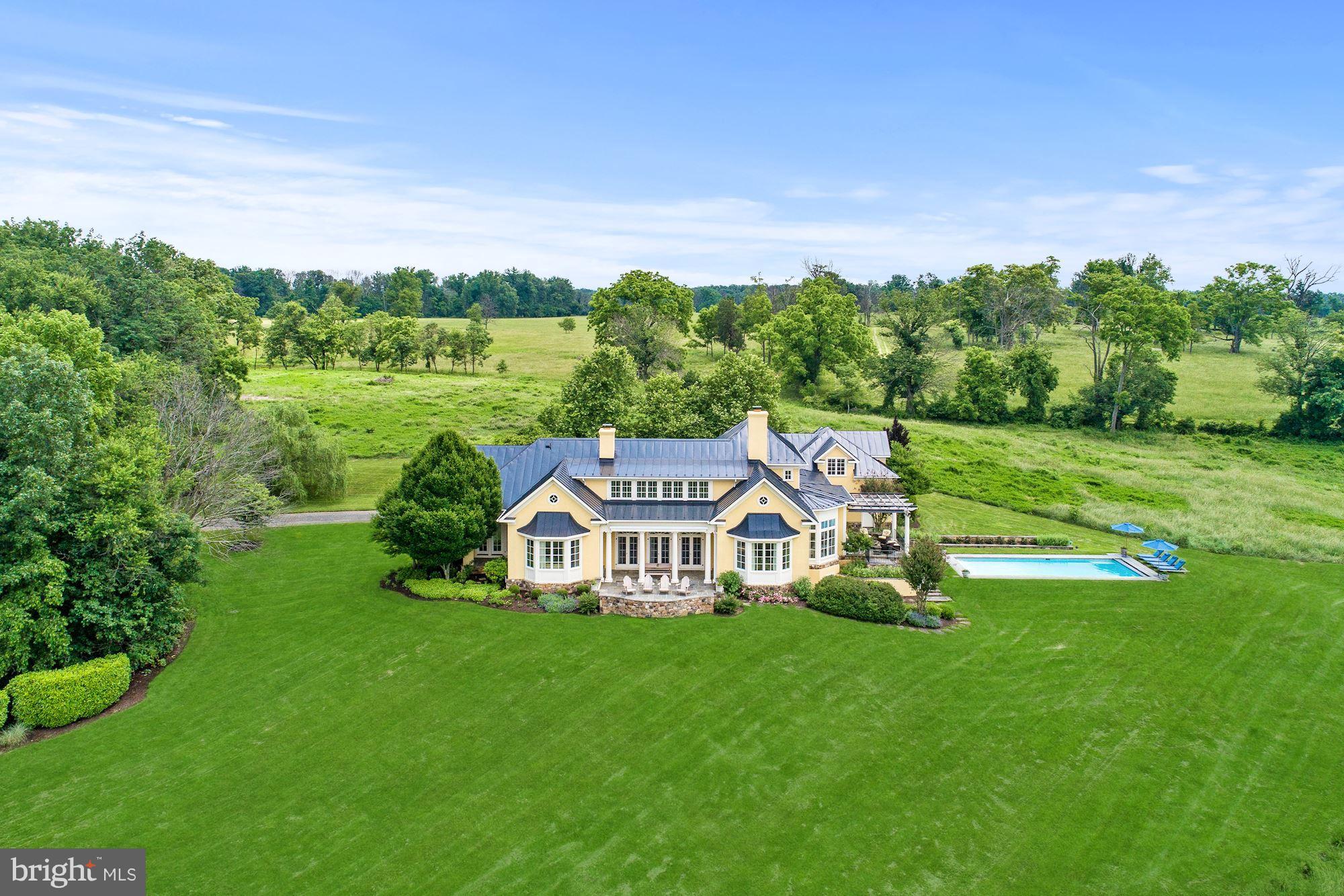 Custom 5000+ sq ft home on 50 acres with gorgeous views! Open floor plan in European Country design.  Gourmet chef's kitchen, sunken living room, den and sunroom.  Main level master suite and full walk-out basement.  Outdoor features include flagstone porches, heated pool, 2 car garage with 1 bed apartment above.