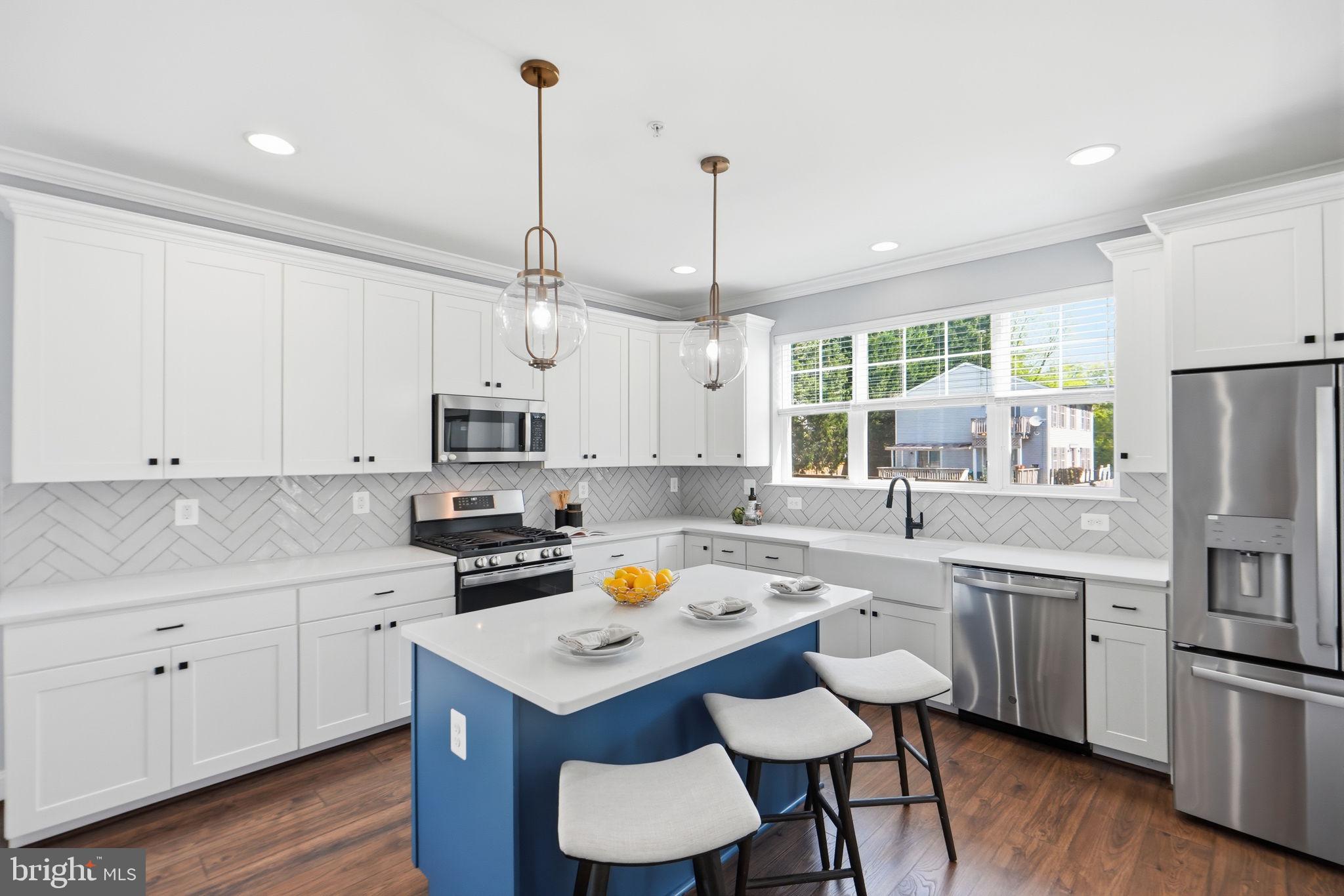 VA Assumable at 5.25%!!!!!   Rare opportunity to own a nearly-new 2022 custom home with over 3,500 finished square feet in Silver Spring for under $900K.   14309 Drayton Avenue delivers something incredibly rare in Silver Spring: a nearly-new custom home with modern design, energy-efficient systems, and over 3,500 square feet of finished living space—all tucked into an established neighborhood with equal access to commuting routes and abundant outdoor space.
Built in 2022 by Sterling Custom Homes, this 5-bedroom, 3.5-bath residence combines the clean lines and open layout today’s buyers want with the comfort and functionality that make a house truly feel like home. Set on a quiet cul-de-sac, the location offers a peaceful neighborhood feel while remaining just minutes from major commuter routes, shopping, dining, parks, and trails.
Inside, the main level was designed for modern living and entertaining. Natural light pours into the open-concept layout, highlighting hardwood flooring, recessed lighting, and seamless flow between the living, dining, and kitchen spaces. At the center of it all is a beautifully appointed chef’s kitchen with quartz countertops, stainless steel appliances, stylish backsplash, abundant cabinetry, and a large island ideal for gathering with family and friends.
The adjoining living room centers around a cozy gas fireplace, creating a warm and inviting everyday living space. Upstairs, the spacious primary suite offers a relaxing retreat complete with a sitting area, spa-inspired bath, and dual vanities. Three additional bedrooms, an upgraded hall bath with double vanity, and convenient upper-level laundry complete the second floor.
The finished lower level adds exceptional flexibility with a large recreation space, fifth bedroom, full bath, and room for a gym, office, media room, or guest suite.
Outside, enjoy a flat private yard with space to entertain, play, garden, or simply unwind. A two-car garage, extended driveway parking, and major systems from 2022 provide the convenience and peace of mind buyers rarely find in resale homes.

For buyers seeking modern construction, functional space, and move-in-ready condition in a well-connected Silver Spring location, 14309 Drayton Avenue is an opportunity that rarely comes available.