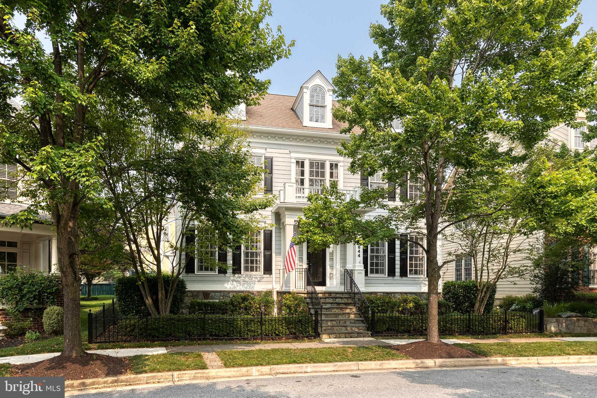 Welcome to 7644 President Street in the heart of midtown Maple Lawn, where timeless craftsmanship, thoughtful updates, and an unbeatable lifestyle come together. Built by Mitchell + Best in 2005, this Hamilton model offers 3,000+ sq ft above grade with soaring 13 ft ceilings, abundant natural light, and elegant architectural details throughout. Situated directly across from a picturesque neighborhood park and just a short stroll to restaurants, shops, community amenities, and top rated Howard County schools, this home offers one of the most desirable locations in the community. Shining hardwood floors flow throughout the expansive dining and sitting rooms before opening into a spacious living room featuring a cozy fireplace and custom built-ins with integrated lighting. The stunning 2022 kitchen is designed to impress with quartz countertops, an oversized breakfast bar island, stainless steel appliances, a gas range with pot filler, abundant cabinetry, and a side butler's pantry, creating the perfect space for everyday living and effortless entertaining. A convenient out of sight mudroom drop zone provides access to the attached two car garage. Just outside, the professionally designed 2020 bluestone patio offers the ideal outdoor retreat with ample space for grilling, dining under the summer stars, and relaxing around a firepit, all with the convenience of a gated rear entrance. The upper level features four generously sized bedrooms and three full bathrooms, while the main level includes a powder room for guests. The fully renovated lower level (2019) adds exceptional living space with a large recreation room, dedicated home gym, impressive wet bar (complete with sink, refrigerator, ice maker and dishwasher), a legal fifth bedroom, full bathroom, ideal for guests, multigenerational living, or entertaining. Additional improvements include dual air conditioning systems replaced in 2024 and 2025. Beautifully updated, exceptionally maintained, and perfectly located, 7644 President Street offers the rare opportunity to enjoy luxury living in one of Howard County's most sought after communities.