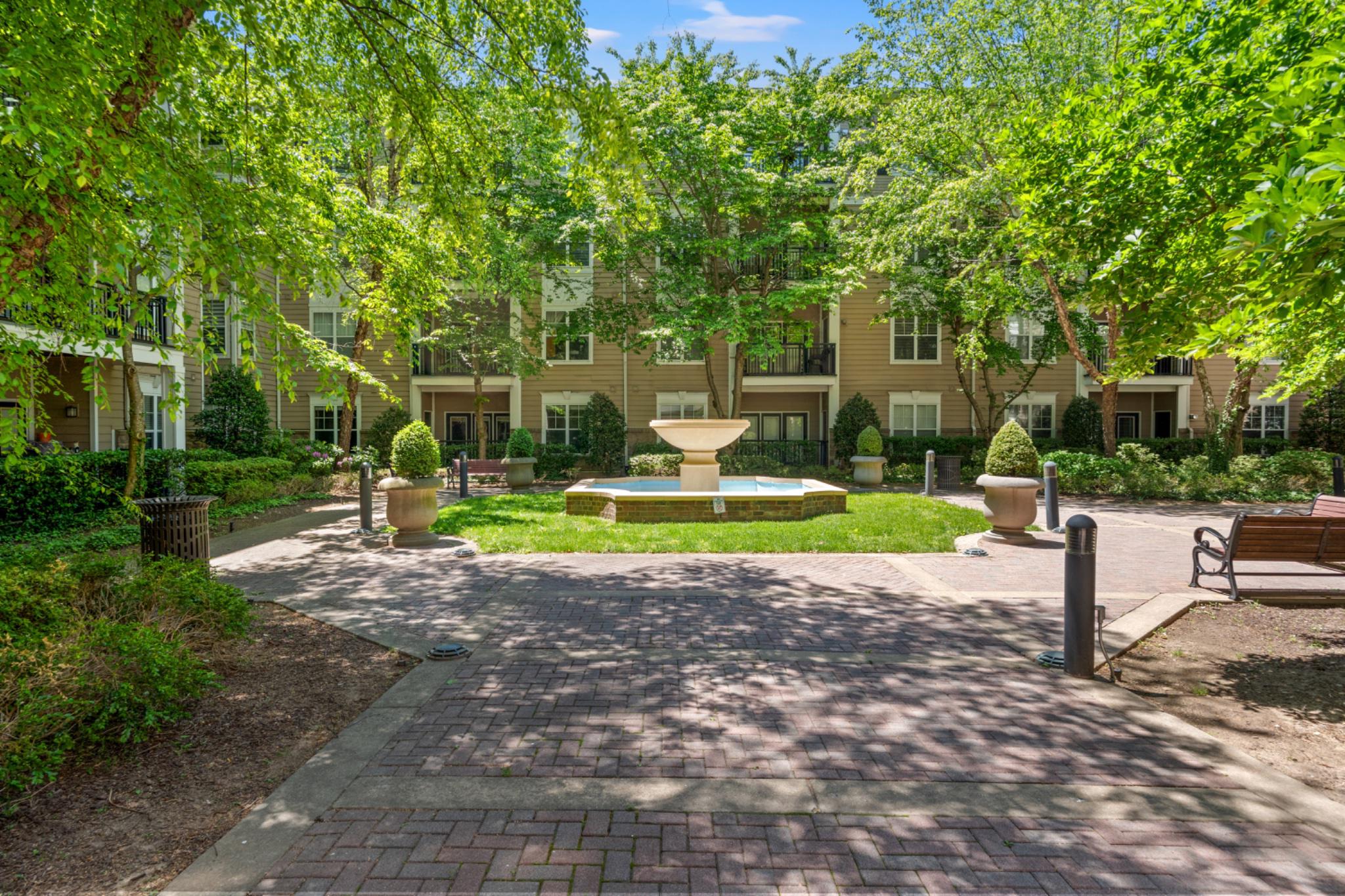 BUYER INCENTIVE - Sellers are offering a credit to purchaser at closing to pay first three months of condo fees!!  Welcome to effortless living at The Fitz—where comfort, convenience, and location come together in one beautifully refreshed residence in the heart of Rockville! This move-in ready two-bedroom, two-bath condo stands out from the competition with MAIN-LEVEL ENTRY with covered garage access just steps away. Whether you’re carrying groceries, walking the dog, commuting daily, downsizing, or simply seeking easier everyday living, this layout offers unmatched accessibility and convenience that buyers crave.  Freshly updated with NEW paint, NEW carpet, and a NEW refrigerator, the home offers a crisp, modern feel from the moment you enter. The stylish kitchen features 42” white cabinetry, granite countertops, stainless steel appliances, gas cooking, and opens seamlessly to the living and dining areas complete with hardwood floors, soaring 9-foot ceilings, elegant crown molding, and a cozy corner gas fireplace. A private balcony overlooking a peaceful, landscaped courtyard is your own quiet retreat in the center of it all.  Additional highlights include a separate laundry room, TWO separately deeded garage PARKING SPACES, and an oversized climate-controlled storage room—rare extras that elevate both comfort and practicality. Major system updates include HVAC (2023), washer (2024), and dryer (2022), offering added peace of mind for years to come. CONDO FEE INCLUDES sewer, cable & high speed internet, secure parking, storage, trash, exterior building maintenance, snow removal, PLUS AMENITIES of on-site management, fitness center, pool, billiards room, theater room, and cyber cafe.  And the location simply cannot be beat—within walking distance to vibrant Rockville Town Center offering an array of dining, shopping and entertainment, Rockville Metro, MARC Train, bus routes, and everyday grocery and convenience needs.  Easy access to Montgomery College and major commuter routes also makes this an exceptional opportunity for professionals or students.  Turn-key, ideally located, and priced under assessed value in 2026 — this is the one to call home!