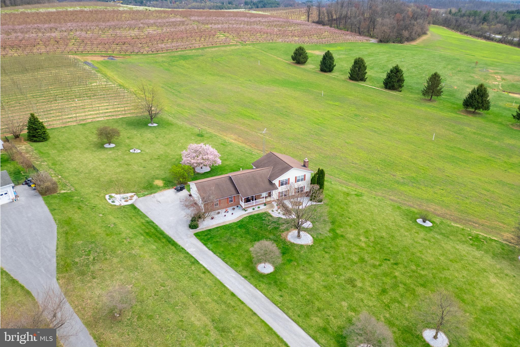 **Charming Home Surrounded by Baugher's Orchard!**  This meticulously maintained, private retreat offers 4 beautifully designed levels—each more impressive than the last. Featuring 3 spacious bedrooms, 2.5 baths, and stunning hardwood floors throughout, this home is truly a must-see. Step into the fantastic living room, where gleaming hardwoods set the stage for a warm and inviting atmosphere. The open floor plan flows seamlessly into the eat-in kitchen, boasting abundant counter space and a breathtaking waterfall peninsula. In 2025 two car garage insulated and drywalled  and in 2019 updated the two garage openers.  Main level laundry and garage off kitchen. Step outside onto the deck and take in the serene views of peaceful farmland. Upstairs, you'll find three generous bedrooms, including a primary suite with an updated ensuite bath and three large closets. The two additional bedrooms share a beautifully updated full bath. The lower level is an entertainer’s dream added in 2021, featuring a spacious family room with a pool table, full wet bar, cozy pellet stove, and luxurious vinyl plank flooring, along with a convenient half bath. The lowest level provides an abundance of storage space.  Meticulously maintained and updated through the years. Including: Water heater 2023, HVAC 2013, Well pump 2017. Everything else remodeled in 2018 to include kitchen, bathrooms, hardwood throughout, very tasteful lighting & recessed lighting, 2 electric panels 150  AMP each. Don’t miss your chance to call this exceptional home your own!