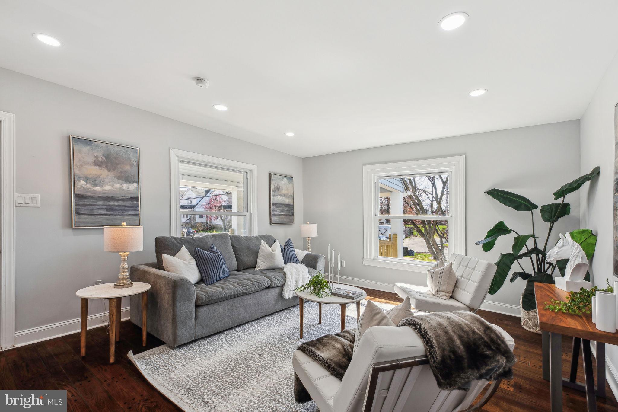 Welcome to this beautifully renovated corner home in Lansdowne, offering four bedrooms, 2.5 bathrooms, and beautiful hardwood floors throughout.

Step into the expansive living room, where oversized windows flood the space with natural light. The seamless layout leads through the original pocket doors into the dining room, which includes a convenient coat closet. From there, enter the kitchen — a true chef’s delight — featuring a spacious island, quartz countertops, a gas stove, and abundant cabinetry. Large windows make this space bright and inviting. A small powder room is conveniently tucked away near the back door.

On the second floor, you'll find three generously sized bedrooms, each with a walk-in closet. The stylish hallway bathroom is beautifully tiled, featuring a wide vanity and a tub-shower combo. A hall closet provides additional storage for linens.

Ascending to the third floor, the primary suite offers a private retreat. The hallway includes two separate closets, while the bedroom itself has two more, ensuring plenty of storage. The en suite bathroom boasts a sleek vanity and a stunning walk-in shower with a built-in bench.

Downstairs, the unfinished basement houses the laundry area and provides plenty of extra storage.

Outside, the oversized front porch is perfect for unwinding at the end of the day. The yard includes a small garden space, while the side yard offers a blank canvas for landscaping or a patio addition.

Don’t miss the chance to make this home yours—schedule your tour today! Offer deadline set for 8 PM Sunday.