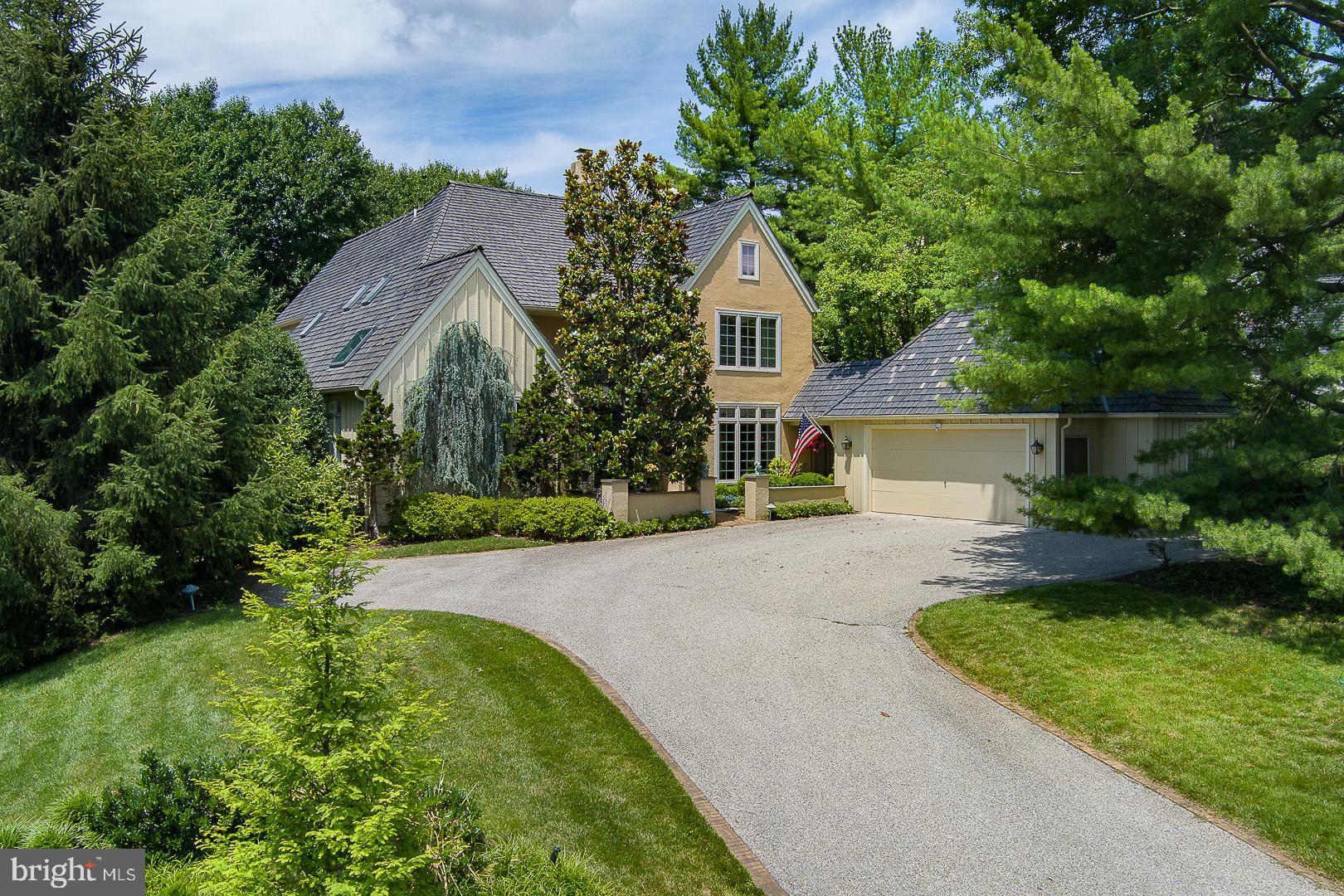 It is no secret that Denbigh remains a very popular and sought after enclave among Buyers today seeking a tranquil, natural setting with 26 acres of permanent open space, gently sloping meadows, a winding stream and beautiful mature trees, with walking paths and no through traffic. A private and almost secluded sanctuary in which to live, among just a few others. Its 19087 location allows for easy and efficient access to almost everything one may want or need - a major convenience today. The Upper Merion Township location provides welcome relief from higher, adjacent property tax assessments. Welcome to 1241 Denbigh Lane, an exceedingly rare Cambridge model, at 3,500+sqft. This is one of very few homes within Denbigh, with a 1st fl owner's bedroom suite, and an attached garage. Advantaged with a premium, highset inner circle lot location for commanding, open and wooded views to the front, backing to open space at the rear for easy access to the grounds and trails, to peace and privacy, just out the back door. The private courtyard driveway allows for an attached, two car + garage, and ample parking. The Cambridge model has become a classic- well lit, with a slightly formal bearing, and great space allocations, but allowing for casual and easy, day-to-day living w excellent flows. Exceptional natural lighting with abundant sunshine, and easy access to the out of doors.  The amenities abound. Two story entrance foyer with 18' ceilings has large, south facing transom window for abundant natural light, with impressive scale. Foyer has hardwood floors, coat closet and powder room with underlighted vessel sink.  Double front entrance doors, hardwood floors. Foyer flows graciously straight through to the full size, formal living room, with no step down!  Living room has fireplace, 18' high ceilings for good scale and great window wall, with atrium door, straight out to the private deck. From the foyer to the right is the sunny dining room, and to the left is the owners main floor bedroom suite. Through the dining room lies white on black island granite kitchen with tile backsplash, breakfast area and bay window overlooking a rock garden.  Island has cooktop and vent, with double wall ovens, a dry bar w clear ice maker and a beautiful hutch desk area. Kitchen opens dramatically to the two story family room with vaulted, 18' ceilings and a stone fireplace hearth.  Family room opens with oversize sliding door w transom window to the large, rear custom deck. Kitchen has rear laundry/mud room and pantry. The owner's full bedroom suite has pretty windows, double doors, a luxe, white marble bathroom with dual walk-in closets, twin bowl vanity and full soaking tub, private WC and glass stall shower with rain head and steam unit, all en suite.   Bedroom suite opens at the rear to the cozy, private library/den with beautiful built-ins, with a sliding glass door to the patio. Foyer has transverse stairs to the second floor, with open balcony landing and two, large en-suite bedrooms, each with sunny windows and very large closets along with full, private bathrooms.  Separate, oversize walk-in storage closet. The first floor laundry room opens to the garage breezeway for access to a heated, two car attached garage.  The full, unfinished lower level has excellent storage capacity and potential to further finish, with a wine storage closet  Spaces in use currently include a workshop, a fitness area and a studio. The very well run HOA attends to all of the landscaping, plowing and maintenance work necessary to keep both the house and community in top notch shape. If easy and elegant living in a parklike environs appeals to you, please come and see this great opportunity at 1241 Denbigh Lane.