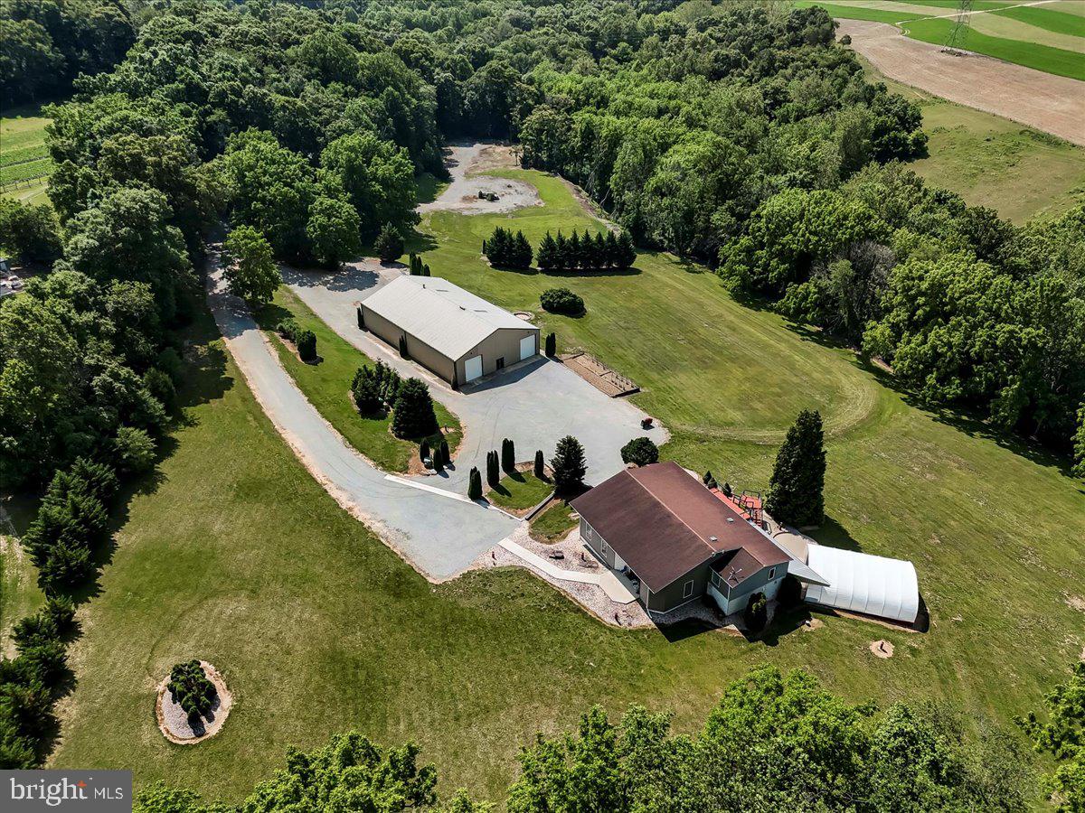 Luxury Living Meets Versatile Workspace on 12.3 Gated Acres

Welcome to 15 Wood Valley Lane—an extraordinary Chester County estate offering the perfect blend of refined living and functional space. Set on 12.3 private, gated acres of scenic countryside, this one-of-a-kind property features a beautifully appointed 4-bedroom, 5-bath main residence, a inground pool and hot tub, and an impressive 60'x100' steel shop with a fully integrated 3-bedroom apartment.

Inside the main home, you'll find expansive, light-filled living areas with tasteful finishes and a warm, inviting atmosphere. The primary suite offers a serene retreat with a luxurious ensuite bath and tranquil views. Each additional bedroom includes its own dedicated bathroom, ideal for family or guests.

Step outside to enjoy the manicured grounds, where a luxurious pool and hot tub area await—perfect for entertaining or relaxing in total privacy.

The massive steel building is a true standout, offering endless potential for business use, hobbies, or storage, and the attached 3-bedroom apartment provides flexibility for multi-generational living, staff quarters, or rental income.

For peace of mind, this property features a hard-wired, whole-house generator. 

There’s room here for everything—horses, gardening, equipment, or just breathing room to enjoy the land. Located in a quiet, accessible spot not far from major routes, this property is ideal for someone who wants space to grow, live, and work—all in one place.
