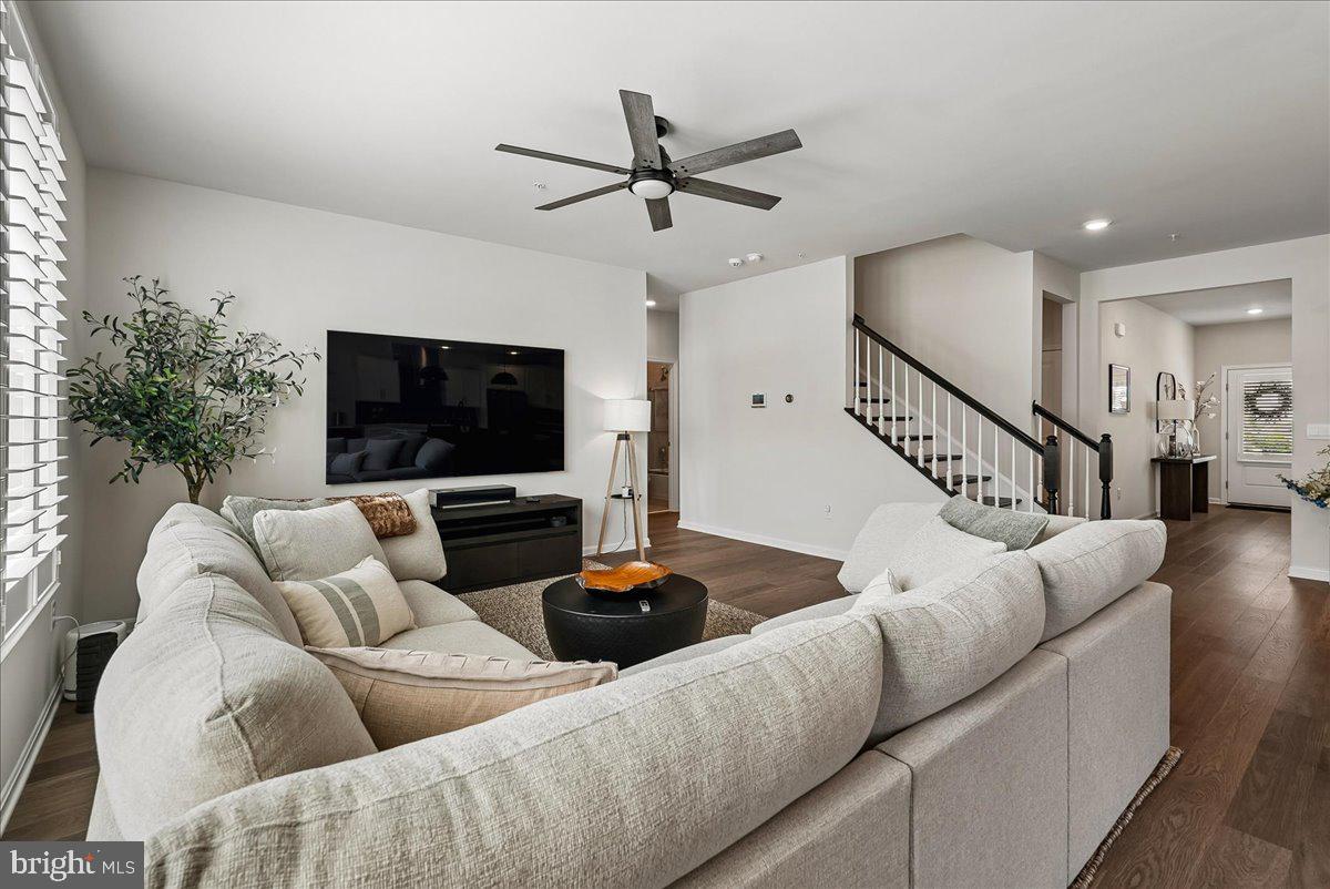 Picture mornings on a private, professionally landscaped patio, motorized shades easing down at the touch of a button. Movie nights with true in-wall and in-ceiling surround sound. A home gym already floored and ready, a home office framed by elegant French doors, and an epoxy-finished garage clean enough to leave open. Every detail of this 2024-built home has been considered — plantation shutters and custom closets throughout, a butler's pantry and kitchen bar made for entertaining, and four-zone smart-home security covering every approach. A whole-home dehumidifier and radon system keep the air as good as the light. With over $90,000 in upgrades, there's nothing left to do but move in.