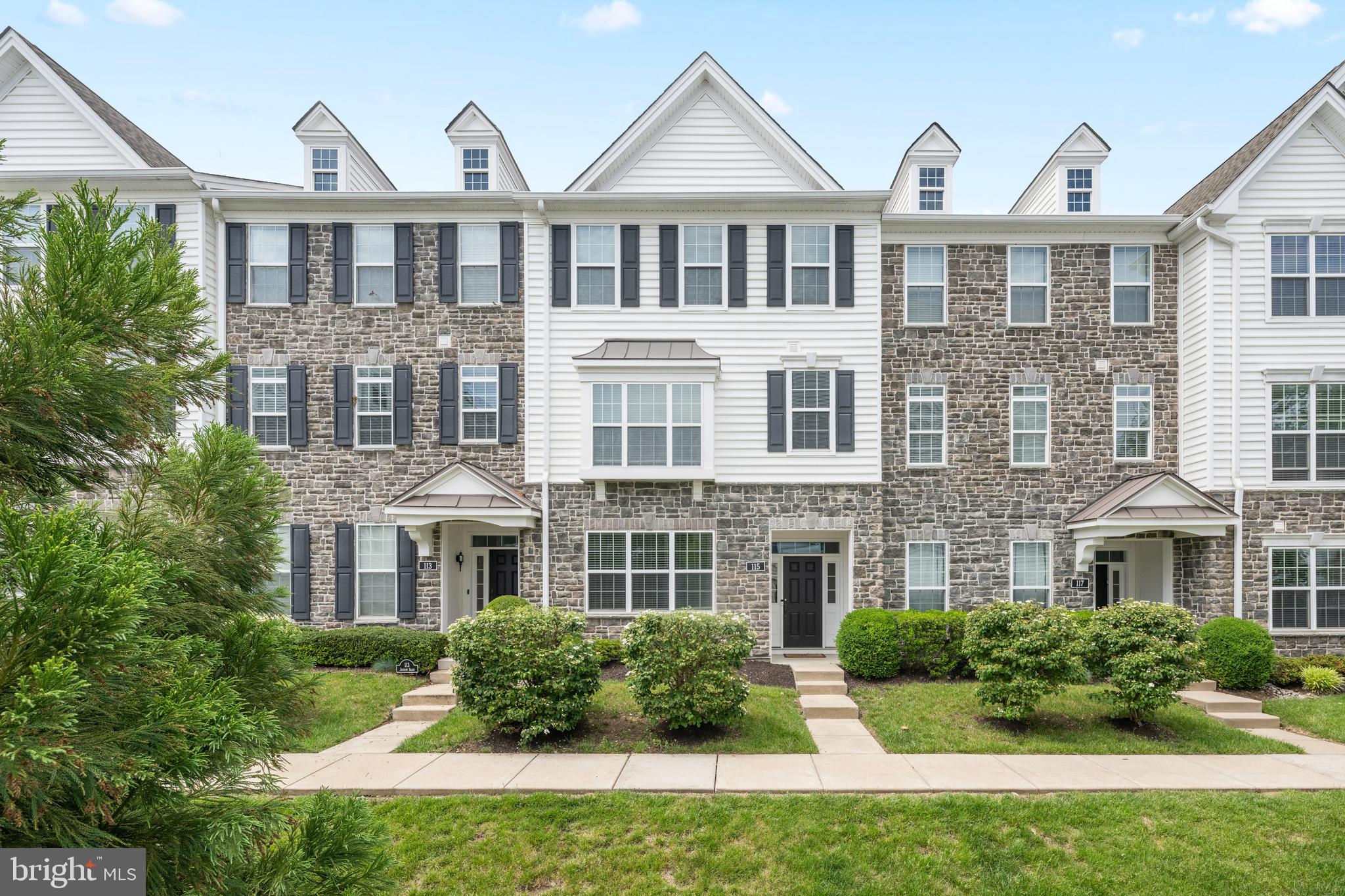 Welcome to 115 Jackdaw Alley,  located in Media’s highly sought-after townhouse community of Ravenscliff. This beautiful 3-bedroom, 2.5-bath townhome offers an open, sun-filled floor plan with 9-foot ceilings, hardwood floors, and oversized windows throughout the main level. Enter into the welcoming foyer with a flex space that can be used as an office, bedroom or media room. The attached 2 car garage is also located on this level. The main floor includes the chef’s kitchen featuring a large island with a double sink, upgraded granite countertops, beveled subway tile backsplash, white soft-close cabinetry, under-cabinet lighting, and a spacious breakfast area. The kitchen opens seamlessly to both the family room and dining area, with sliders leading to a low-maintenance composite deck—perfect for relaxing or grilling. Upstairs, the primary suite features a tray ceiling, walk-in closet, additional slider closet, and a beautifully appointed bath with a double vanity and an oversized custom walk-in shower with bench seat. Two spacious secondary bedrooms, a hall bath with tub/shower combo, and a convenient second floor laundry area with full-size washer and dryer complete the upper level. Ideally located just minutes from historic downtown Media’s boutiques, dining, entertainment, and "Dining Under the Stars." Ravenscliff also offers easy access to I-476, Route 1, a short drive to the Philadelphia International Airport and the SEPTA train to Center City Phila has a stop in Media.