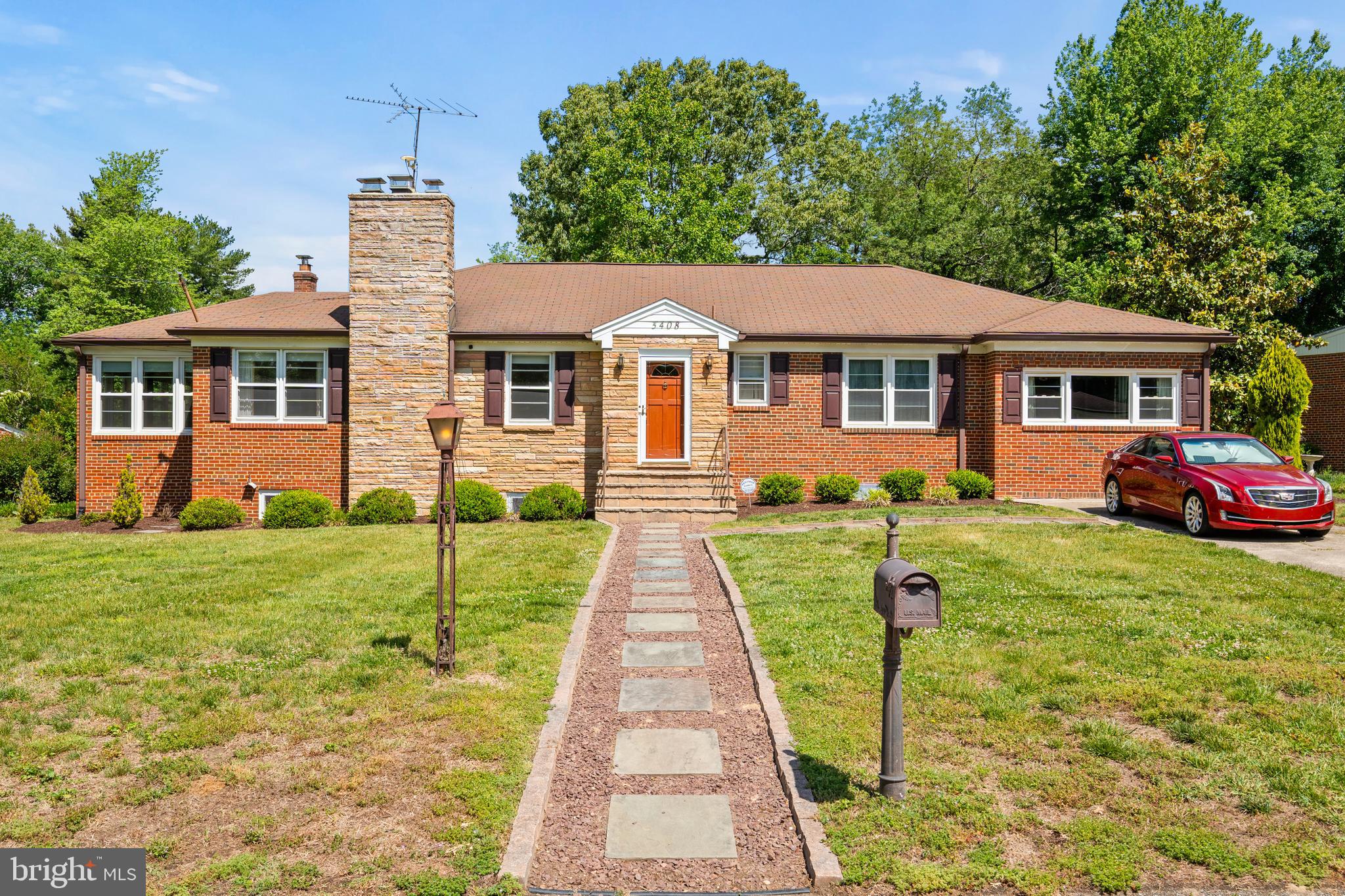 This charming solid stone-and-brick rambler offers timeless character, spacious living areas, and an incredible opportunity to create your dream home in a well-established neighborhood. Featuring 4 bedrooms and 3 full bathrooms, with a private driveway and perched on a nearly half acre lot, the home showcases classic craftsmanship. Hardwood flooring is beneath much of the existing carpet, with two wood-burning fireplaces, generous room sizes, and an abundance of natural light throughout. The main level welcomes you with a ceramic tile foyer, spacious living room with brick fireplace and stone shelving, formal dining room with hardwood floors and chair rail, and a bright sunroom addition featuring a wood ceiling, built-in bookshelves, ceiling fan, and updated windows—perfect for relaxing, reading, or entertaining year-round. The kitchen offers excellent functionality with double wall ovens, stainless steel refrigerator and dishwasher, glass cooktop, large pantry, and direct access to the backyard, providing a fantastic canvas for future customization and updates. The bedroom wing includes a spacious primary suite with crown molding, double-deep closet, and private ensuite bath, along with three additional bedrooms featuring hardwood flooring beneath carpet, ceiling fans, built-ins, and updated windows. A full hall bath and attic access with pull-down stairs add additional convenience and storage. The expansive lower level offers incredible versatility with a massive finished recreation room centered around a brick fireplace with insert, built-in dry bar with mirrored accent wall, built-in cabinetry, and multiple windows bringing in natural light. A finished bonus room with two closets, full bathroom, utility/storage room, and walk-up access to the backyard create endless possibilities for guests, hobbies, office space, or multigenerational living. Major system updates include an HVAC system approximately 4 years old, a brand new oil tank and a large hot water heater. Outside, enjoy a large fenced backyard with mature trees, brick paver patio, storage shed with concrete floor, multiple gates, and ample outdoor space for entertaining, gardening, pets, or play.  Conveniently located near shopping, dining, parks, and commuter routes, this home offers easy access to Suitland Parkway, Pennsylvania Avenue, I-495, Joint Base Andrews, Washington, DC, and nearby Metro stations. Enjoy proximity to local parks, recreation centers, grocery stores, and everyday conveniences while still being just minutes from downtown DC, National Harbor, and Northern Virginia.   Note: Property is being sold in AS-IS condition.
