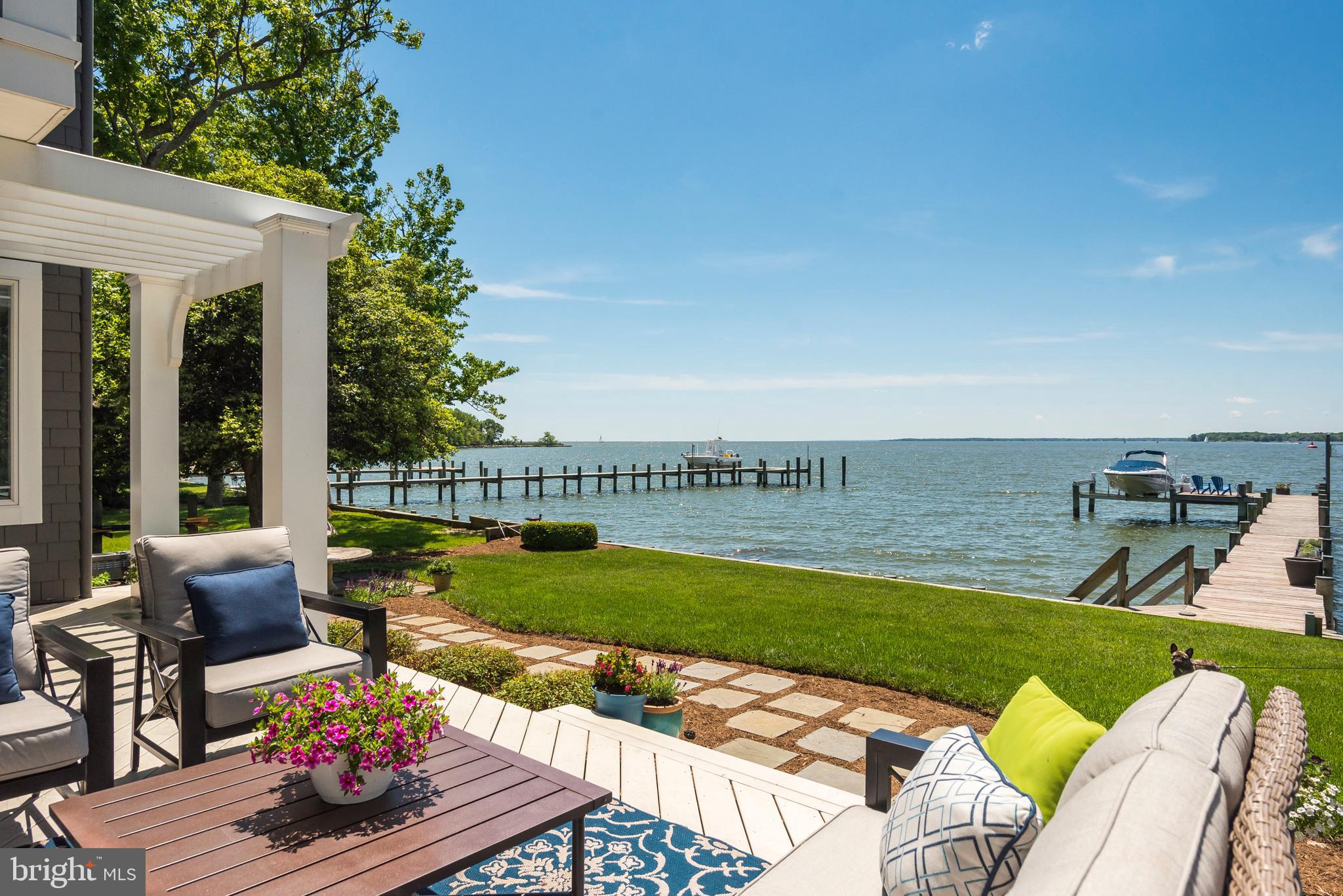 Priced to Sell!!!  Nantucket-Style Elegance in this Purple-Cherry designed waterfront home with a 12' elevation above MLW.  The South River water frontage at the mouth of the Bay are calling boaters to come and enjoy. Main level bedroom or den with water views and full bath.  Open floor plan with generously sized rooms with versatile spaces.  Water views from just about every room in this gorgeous home.  Hard wood floors on every level.  Large master suite with 2 fireplaces and dedicated His and Hers closets.  Bedroom level laundry and home office with Fishing Creek water views.  Third floor offers significant versatility with water views:  rec room, play room, exercise space, guest room, etc.  Large walk-in storage area on third level.  The immediate water views will take your breath away from the moment you enter this lovely, inviting home!