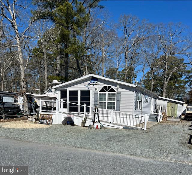 Welcome to this Skyline Manufactured Home. This beautiful spacious 3 bedroom 2 full bath double wide beach home in a marina community has much to offer, and is only seconds away from the bay and the docks. The marina leads out to Rehoboth Bay with access to the ocean. Pebbles surround this home for an easy maintenance beach get away. The house has an alley behind it to help move boats/toys in and off of lot with a outdoor storage box and a built on shed. Each bedroom is a nice size with full size closets. The kitchen is huge with plenty of storage space, an island, and vaulted ceilings. Off the kitchen on one side is a generous size laundry room/utility room. On the other end of the kitchen is a full sun room with a dining room table with sliding glass doors to the screened in porch. The master bathroom has a huge shower.There is a 10x14 screened in front porch, 10x12 shed with ramp. The pool is located directly down the street over looking the bay. Boat docks are available to rent. HOA is voluntary. 1 hour notice is required. House is NOT furnished. Must apply for park approval. Lot rent is $10380 Per Year with a renewable lease yearly. If paid in full yearly there is a 400.00 discount. The extra 30.00 is a state relocation trust fund. Closing costs include a 3.75% DMV Document and Settlement Fee which will be split 50/50. Bring ALL OFFERS!!!