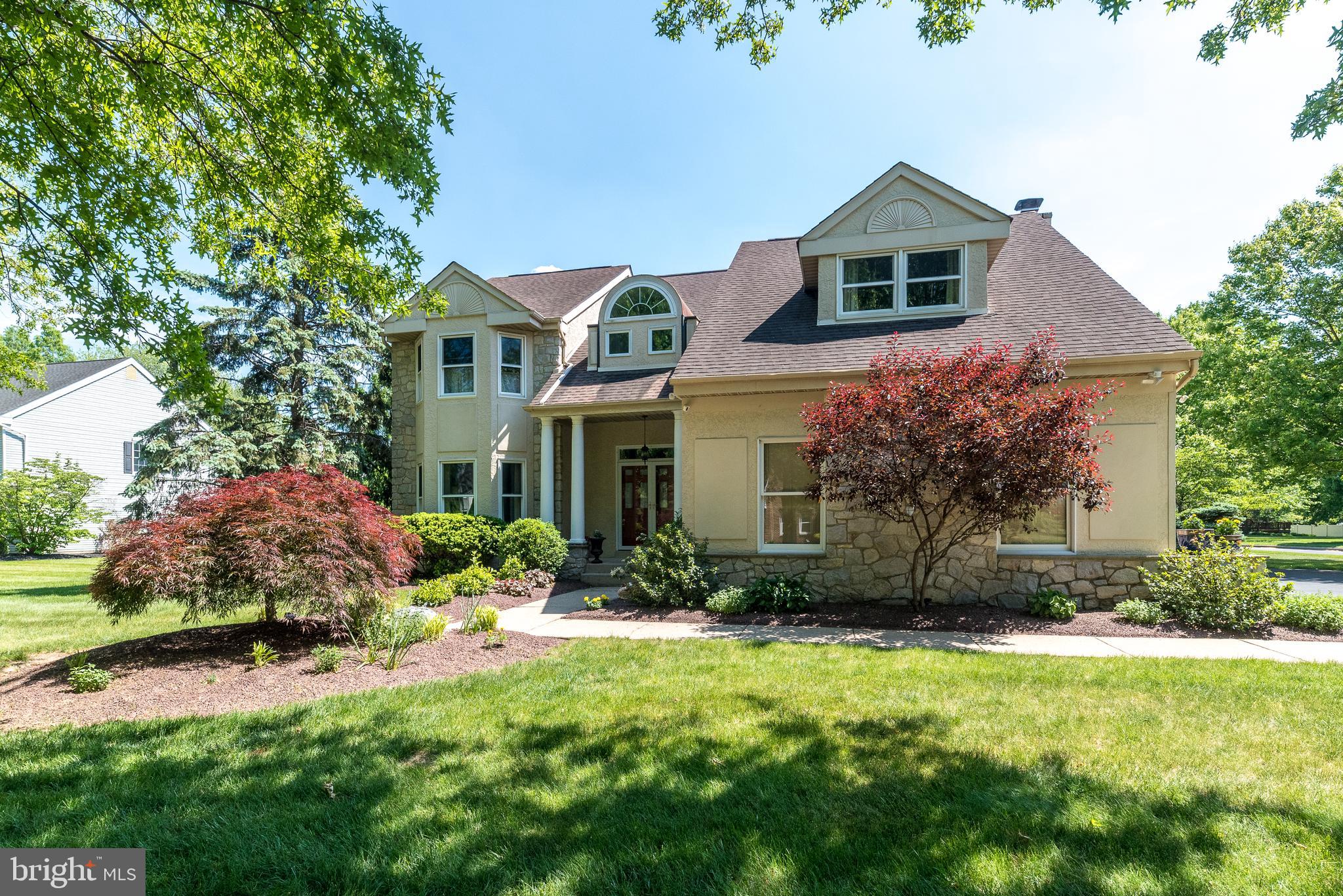 Welcome to 100 Grouse Court, a beautifully renovated 4-bedroom, 2.5-bath home offering exceptional curb appeal and nestled on a picturesque cul-de-sac lot of over half an acre in the highly sought-after community of Mallard Pond. Lovingly maintained and thoughtfully updated throughout, this move-in-ready home showcases true pride of ownership and offers the perfect combination of elegance, comfort, and modern convenience. Ideally located near Windlestrae Park's 73 pristine acres of walking trails, sports fields, and playgrounds, as well as the Montgomery Twp Recreation Center featuring fitness facilities, courts, indoor track, and splash park, this home delivers an incredible lifestyle both inside and out. As you arrive, you'll immediately appreciate the meticulously manicured lawn, colorful flower beds, and inviting walkway leading to the covered front porch. Step through the double front doors into a sun-drenched two-story foyer highlighted by a graceful turned staircase and balcony overlook above. Fresh neutral paint and beautifully refinished hardwood flooring flow throughout much of the home, creating a warm and sophisticated atmosphere. To the left of the foyer, the spacious living room is filled with natural light and flows seamlessly into the formal dining room, providing the perfect setting for holiday gatherings. Just beyond the dining room is the screened-in porch complete with a relaxing hot tub, an ideal retreat to unwind after a long day and offering tranquil views of the private backyard.  The heart of the home is the stunning, newly renovated kitchen. Designed with both beauty and functionality in mind, it features crisp white cabinetry, a dedicated coffee station, granite countertops, a stone backsplash, pantry storage, stainless steel appliances, and elegant large-format travertine tile flooring. The adjoining breakfast area is bathed in natural light from numerous windows and skylights equipped with convenient remote-controlled electric shades. Open to the family room, this space is ideal for entertaining and everyday living. A cozy wood-burning fireplace with granite hearth anchors the family room, creating a warm and inviting gathering place during the colder months. The main level also includes a spacious laundry room with utility sink and built-in cabinetry, a convenient powder room, and access to the oversized garage featuring a freshly epoxied floor and two new garage door openers with battery backup. Upstairs, the hardwood flooring continues throughout. A bright loft area with built-in seating provides a cozy reading nook or flex space. The primary suite serves as a true retreat, featuring vaulted ceilings, a sitting area perfect for relaxation or yoga, a generous walk-in closet, and a spacious en suite bath with double granite vanity, soaking tub, and a private shower and commode area. Three additional spacious bedrooms offer ample closet space and share a well-appointed hall bathroom featuring a double granite vanity and a private shower and commode area for added convenience. The huge unfinished basement with durable epoxy flooring provides tremendous storage capacity and unlimited potential for future finishing to suit your needs. Additional upgrades and features include all replacement windows, a high-efficiency heat pump HVAC system, whole-house humidifier, hot water heater (2023), water softener, radon mitigation system with newer fan, pressure nozzles installed on exterior hoses, sewer lateral replaced with PVC (2018), and a sump pump with water-pressure backup for added peace of mind. A generator is also included, ensuring preparedness during unexpected outages. Conveniently located near Routes 309 and 202 and just minutes from the Montgomery Mall area, residents enjoy easy access to an abundance of shopping, dining, entertainment, and major commuting routes. With its exceptional updates, beautiful setting, and unbeatable location, 100 Grouse Court is the home buyers have been waiting for.