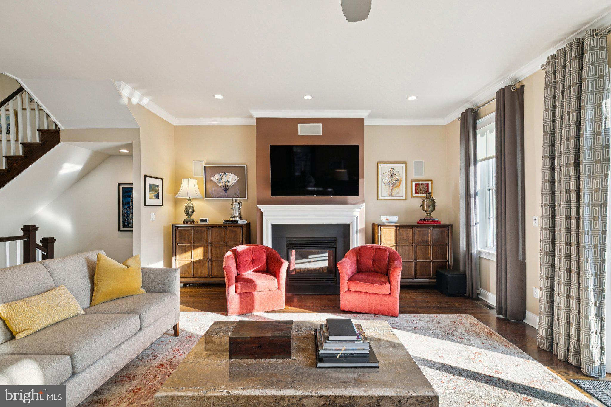 A grand modern residence commanding the prominent corner of 17th and North Streets, this Cope Linder–designed townhome is a standout example of contemporary urban living. With North, South, and West exposures, the home is filled with natural light throughout the day, while its corner orientation gives it a distinguished presence within the Art Museum/Fairmount neighborhood.

A marble entry hall sets the tone upon arrival, offering a sense of scale and refinement. This level includes elevator access to the upper floors, a coat closet, basement access, and direct entry from the fully covered two-car garage with built-in central vacuum. To the right of the foyer, a versatile den serves beautifully as a fourth bedroom, in-law suite, guest quarters, or home office, complete with a full bath featuring a glass vanity and a glass-enclosed tub/shower combination.

The second level opens to an expansive living and dining room spanning the 26-foot width of the home. A gas fireplace anchors the living area, while oversized windows capture abundant light from the home’s corner exposures. A south-facing deck extends from the living room, creating an easy indoor-outdoor connection for everyday living and entertaining.

The chef’s kitchen is both warm and functional, featuring abundant cabinetry, a large island, bay window overlooking North Street, Viking six-burner range with double ovens, Viking refrigerator, wet bar, and a breakfast area with wine and beverage refrigeration. A powder room with tasteful wallpaper sits between the kitchen and stair hall.

The third floor hosts three well-proportioned bedrooms and a hall bath. The front-facing bedroom features a Juliette balcony and spacious closet, while the second bedroom enjoys excellent light and its own well-sized closet. A marble hall bath with double sinks, marble vanity, and tub-shower combination serves the floor, along with a conveniently located laundry station near the primary suite.

The primary suite is a calm retreat with a walk-in closet and a spa-like bath featuring double sinks, marble vanity, a glass-enclosed quartz shower, and a dedicated bathroom closet — a refined European detail rarely found in city homes.

At the top of the home, a pilot house with full wet bar opens directly to a roof deck with panoramic views across Fairmount and the Center City skyline — an ideal setting for sunset gatherings and city entertaining.

The finished, carpeted lower level provides flexible space for a family room, gym, playroom, or media lounge. Additional highlights include elevator access to all levels, multiple outdoor spaces, abundant storage, and secure two-car garage parking.

Just steps from Fairmount Avenue’s dining scene, the Philadelphia Art Museum, the Barnes Foundation, the new Calder Gardens, and the cultural institutions of the Benjamin Franklin Parkway, this exceptional residence offers a rare blend of architectural distinction, modern comfort, and urban convenience.