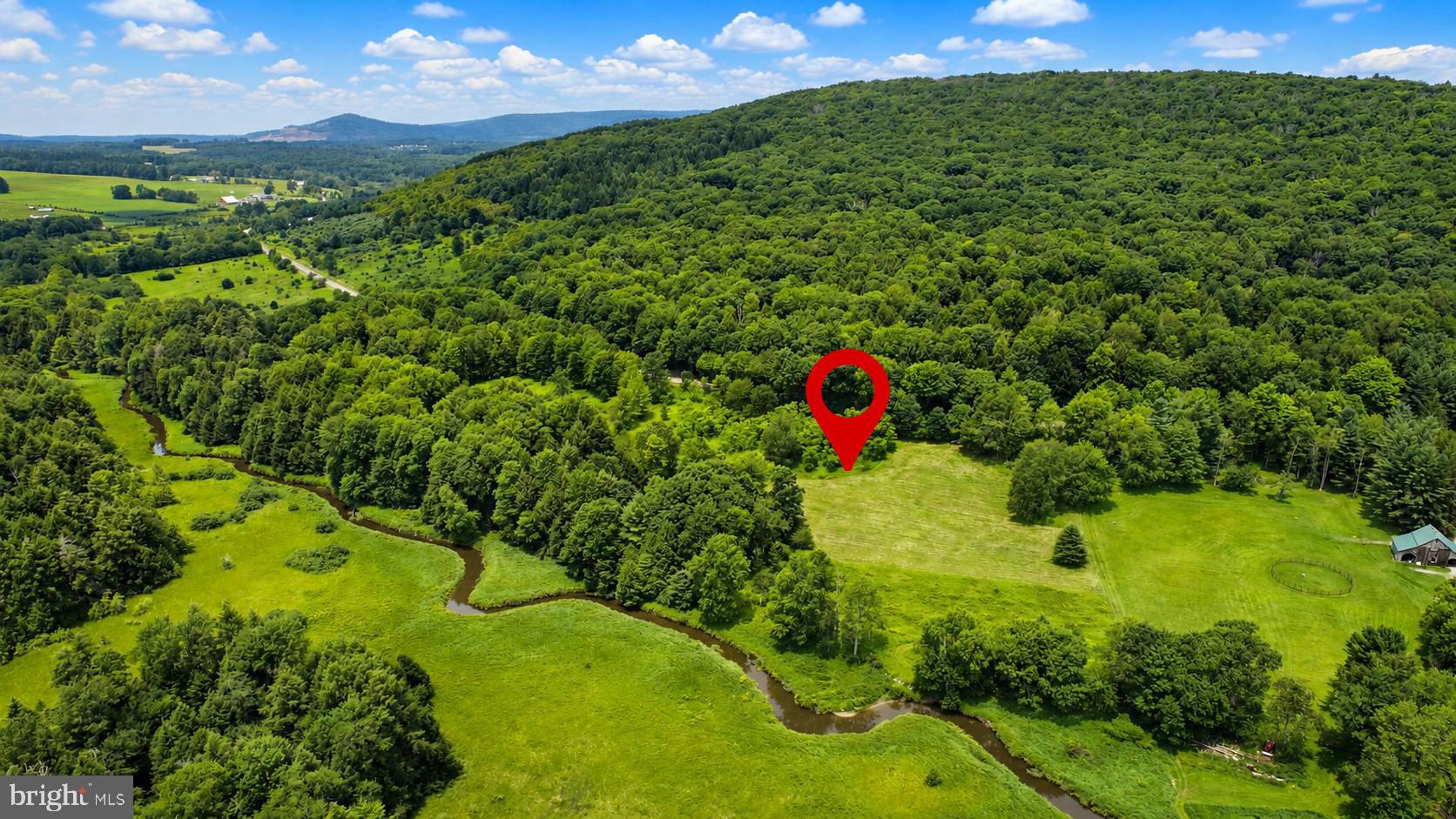 Discover one of Garrett County's most unique homesites, where Muddy Creek flows along the rear of the property and protected Nature Conservancy land creates an unmatched sense of privacy. Ideally situated near  Swallow Falls State Park, Herrington Manor State Park, Piney Mountain, and Garrett State Forest, this property offers access to some of Maryland's finest hiking, fishing, mountain biking, and outdoor recreation. The gently sloping lot features a beautiful mix of mature hardwoods, open lawn, and mountain views with southern exposure—an exceptional setting for your future mountain retreat. Survey completed, approved for a 4-bedroom home, and the driveway is already installed, allowing you to begin building sooner. A truly rare opportunity to own a private homesite surrounded by thousands of acres of protected natural beauty.
