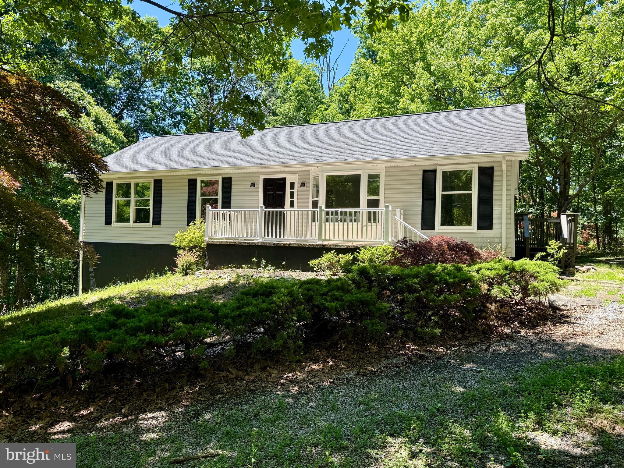 Welcome to this beautifully remodeled ranch home with a walk-out basement, situated on two wooded lots offering privacy and room to enjoy the outdoors. The spacious main level features 3 bedrooms and 2 full bathrooms, along with fresh paint and luxury vinyl plank flooring throughout. Enjoy peace of mind with a brand-new HVAC system. The stunning kitchen has been completely updated with new cabinetry, granite countertops, stainless steel appliances, LED lighting, and luxury vinyl plank flooring. French doors lead to the rear deck, creating the perfect space for grilling, outdoor dining, and tranquility. The adjoining dining room provides a welcoming setting for everyday meals and gatherings. The living room overlooks the front porch through a large picture window, filling the space with natural light. The primary suite offers two generous closets and a private en-suite bathroom, while two additional bedrooms and a second full bath complete the main level. The walk-out basement includes a beautifully finished flex space enhanced by large windows that allow abundant natural light to pour in, making it ideal for a family room, home office, fitness area, playroom, or hobby space. Additional unfinished space provides excellent storage or future expansion potential. Combining tasteful updates, versatile living areas, and a serene wooded setting, this move-in-ready home is one you won't want to miss. Schedule your private tour today!