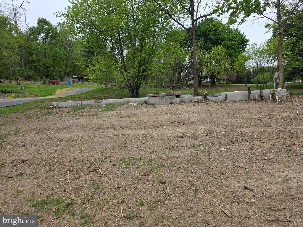 Corner lot on quiet South Mountain Road just south of Dillsburg and less than 3 miles from US 15.  This lot is very unique.  Near the roadside there is a block foundation (24'x48') with water, sewer and electric.  There was a double-wide on the foundation, but it was demolished and removed.  This is your perfect opportunity to place a new mobile, modular, or construct a new home on the site.

This 1.10 AC lot has trees and a shed but needs some landscape work.  With some vision, this could be a very nice homesite.  Taxes reflect property with a double-wide home on site and have not been adjusted since it was removed a few months ago.