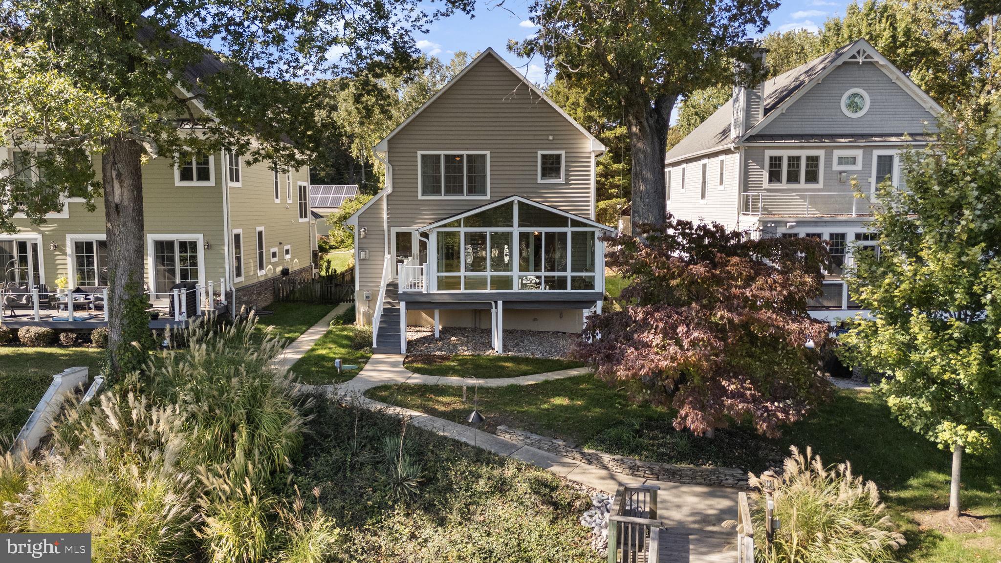 Waterfront living at its finest in newly renovated and updated home on Deep Creek with easy access to the Magothy River, Chesapeake Bay, and downtown Annapolis!  Unique location where you can kayak, paddle-board, or canoe to protected nature preserve, use a power boat or sailboat to explore the Magothy, Bay, and surrounding areas, and walk or take any boat option to Donnelly's Dockside restaurant.  Besides a prime location tucked away on a quiet street with convenient commutes to Annapolis, Baltimore, and DC in the Broadneck school district, nothing has been overlooked with this home offering the perfect combination of comfort, style, and natural waterfront living.  From the moment you drive onto the property, it feels like a luxury retreat immersed in nature with the street-side yard including a pond of bullfrog residents and occasional duck visitors, water side yards and pier, and well-designed window placement throughout the house allowing natural light and views of trees, sky, water, and flying and swimming creatures like bald eagles, osprey, ducks, seagulls, songbirds, muskrats, and the occasional otter.  This home is tastefully updated and remodeled throughout with exquisite, top-of-the-line custom finishes and thoughtful design details like hardwood flooring and waterfront views from nearly every room.  Loads of windows, all season sunroom, and atrium doors across the front fill the home with natural light all day long!  Custom painted throughout with neutral, coastal tones, every detail of this home’s remodeling has been thoughtfully considered from the kitchen rebuilt in 2024 to the new steps leading down the hill to the new pier, bulkhead, and boat lift in 2016/2017.  Even dredging was done in the creek and spur under the boat lift to ensure easy boating access.  The beautifully landscaped yards include children’s amenities—a clubhouse, swings, and basketball hoop—and the stylish concrete and brick-designed driveway provides ample parking leading directly to the attached two-car garage.  Additional highlights include electricity and plumbing at the pier featuring a solar-sensor pier light that can be operated from inside and outside the home, a new roof (including sunroom) in 2016, new BAT septic system in 2024 (which was moved street-side to allow water-side hardscaping options), french drains in water-side yard (2018), drains added to driveway to redirect run off (2016), re-pipe and upgrade of all plumbing pipes to code (2024), EV charger in garage (2019), all new flooring (2024), and upgraded water treatment system to accommodate lawn irrigation (2019).  All of this and more to ensure low-maintenance living.  With voluntary membership in the Shore Acres Improvement Association, you can enjoy and walk to community events and amenities like the playground, clubhouse, and Magothy River beach, boat ramp, and recreation area.  This home offers the perfect combination of comfort, style, and true waterfront living immersed in nature and with access to all water activities.