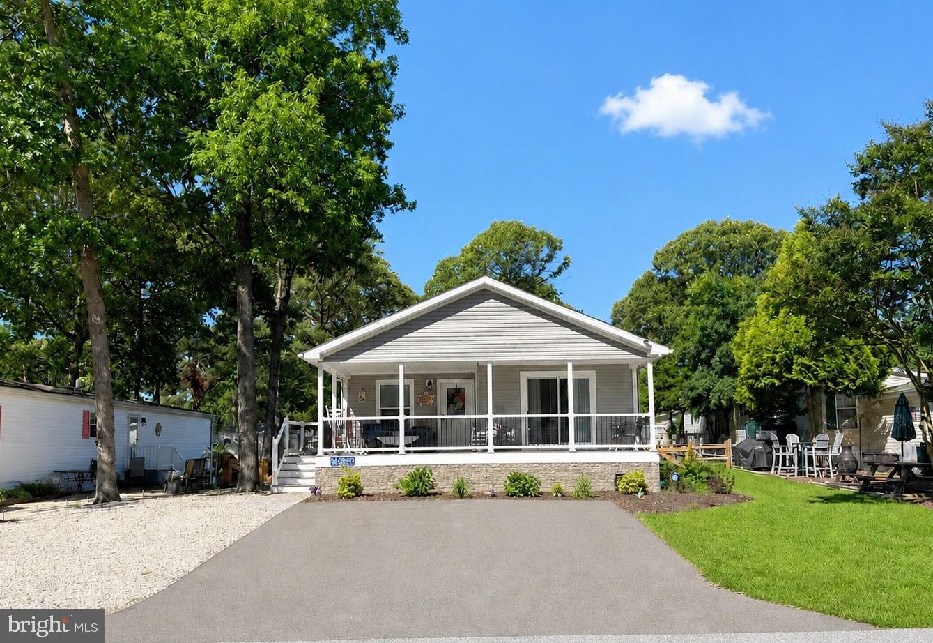 Located in highly desirable Pot-Nets Lakeside, this beautifully maintained 2023 Commodore home offers the perfect blend of modern comfort and easy coastal living. Known for its scenic lake with fountains, walking trails, community pool, and active community center, Pot-Nets Lakeside provides a peaceful setting while still being just a golf car ride away from the private beaches, marinas, and waterfront dining of neighboring Pot-Nets communities. Offering approximately 1,313 square feet of living space, this home features three bedrooms and two full bathrooms with an open-concept layout designed for both everyday living and entertaining. The home’s 9-foot ceilings create an airy, spacious feel throughout. The stylish kitchen is the heart of the home, complete with black stainless-steel appliances, a large center island, and plenty of cabinet and counter space. Durable LVP flooring runs throughout the living areas and bathrooms, adding both beauty and easy maintenance. Step outside to enjoy the inviting front porch with composite decking, perfect for relaxing after a day at the beach. The fenced backyard provides a great space for little ones and puppy dogs to safely play, while the 12x12 shed with electric offers excellent storage for all your beach toys, golf car accessories, and outdoor gear. This well-maintained home is a terrific opportunity to enjoy the coastal lifestyle in one of the area's most sought-after waterfront communities. Schedule your private showing today!