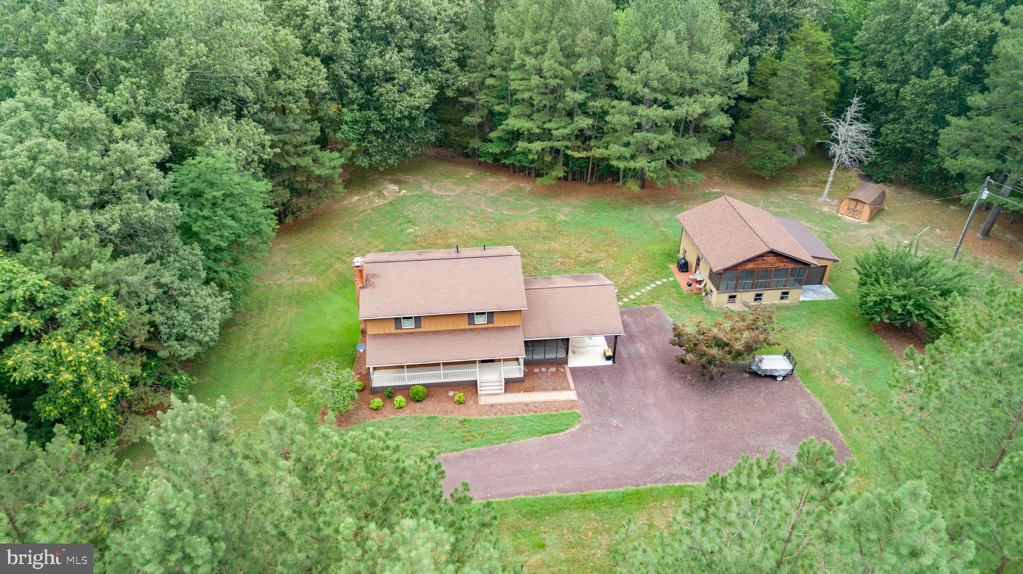 Discover over 22 picturesque acres featuring a main residence, a second dwelling full of potential, and the peace and privacy you’ve been searching for. The meticulously maintained main home offers 3 bedrooms, 2.5 baths, hardwood flooring throughout most of the home, a spacious unfinished basement, central vacuum, a gas fireplace, covered front porch, screened side porch, and an attached carport. The unfinished basement includes a brand-new wood stove that has never been used.
Numerous updates provide peace of mind, including a new HVAC system (April 2026), main house roof (2015), replacement windows and siding (2010), water heater less than 3 years old, and a refrigerator that’s only one year old. The furnace is equipped with an electronic air filter, and the gutters feature leaf guards for low-maintenance living. The home is served by a 450-foot artesian well and two septic tanks, both recently inspected.
The property also includes a second dwelling with electricity, running water, a working full bathroom, kitchen area, washer and dryer hookups, its own septic system and drain field, a large screened porch, and an attached garage with overhead doors on both the front and rear. While the structure does not currently have heating or air conditioning and is ready for restoration, it offers outstanding potential for a guest house, workshop, hobby space, or other future uses. The roof was replaced in 2010 with new shingles installed in 2020, and the water heater is less than one year old.
Surrounded by mature trees and open space, this exceptional property offers the privacy, flexibility, and peaceful country setting that are becoming increasingly difficult to find. All Points Broadband internet service is available. If you’ve been searching for acreage with a very well maintained home and an additional structure full of potential, this is a property you won’t want to miss.