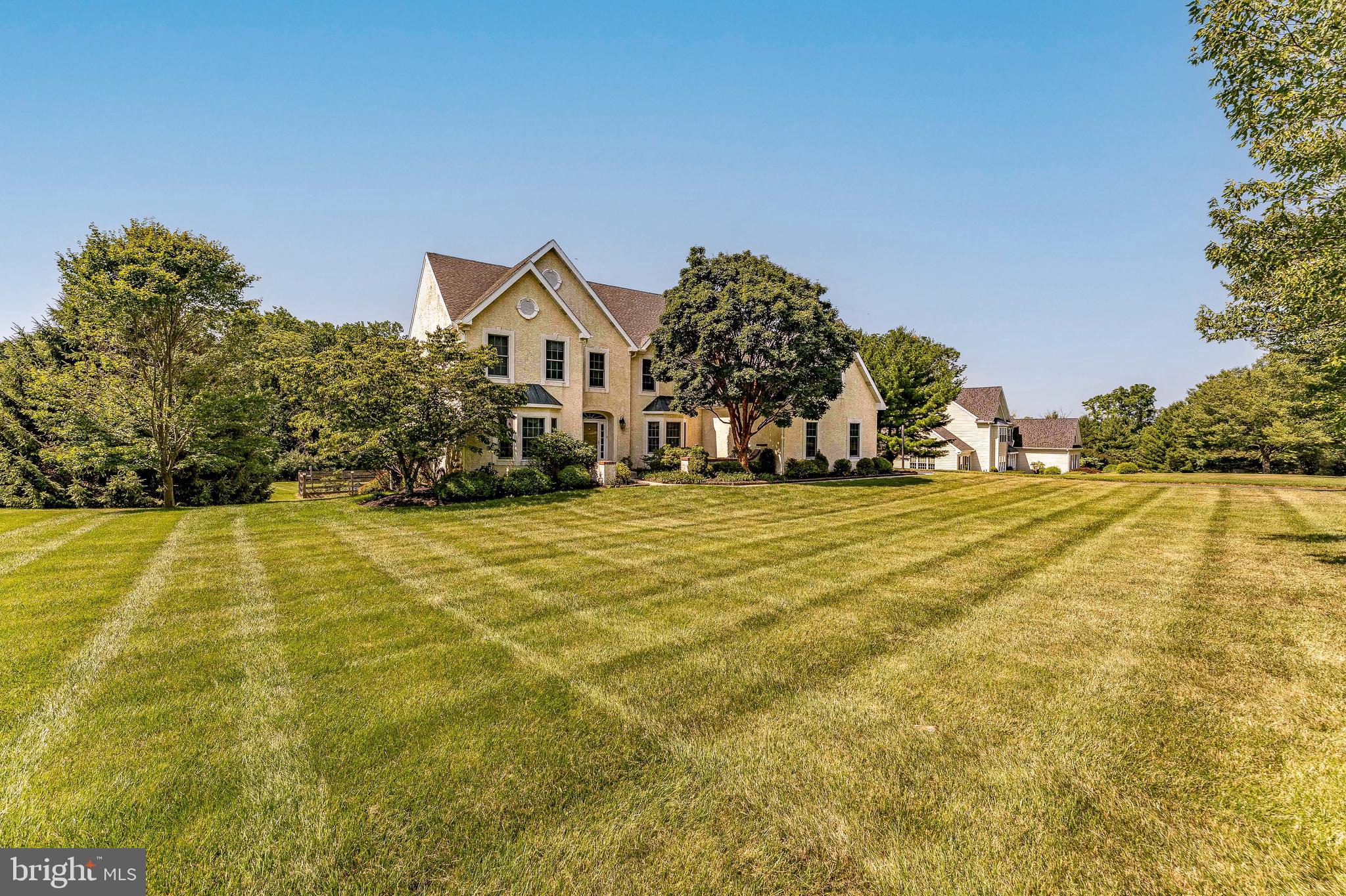 Welcome to 7 Summerhill Drive, a beautifully maintained 5-bedroom, 3-bathroom single family home in the desirable Brandywine Pointe community of Downingtown. Offering spacious living areas, thoughtful design, and exceptional indoor and outdoor living spaces, this home is perfectly suited for both everyday living and entertaining. As you approach the home, you'll be greeted by an inviting front yard, an attached 3-car garage, and a driveway with parking for additional vehicles. Inside, a two-story foyer with hardwood floors welcomes you into the home. To the left, the formal living room features carpeting, crown molding, recessed lighting, and an inviting atmosphere for gathering with family and friends. Across the foyer, the elegant dining room showcases hardwood floors, a tray ceiling, chair rail with wainscoting, and a beautiful bay window that fills the room with natural light, creating the perfect setting for holiday meals and special occasions. Just beyond the living room is a full bathroom with tile flooring and a step-in shower. A private home office with carpeting and a ceiling fan provides an ideal work from home space. The impressive family room serves as the heart of the home, featuring a vaulted ceiling, skylights, plush carpeting, and a striking stone mantel wood-burning fireplace. The open layout flows seamlessly into the kitchen, where hardwood floors, quartz countertops, a large center island with seating, pendant and recessed lighting, stainless steel appliances, a gas cooktop, double ovens, a farmhouse sink with garbage disposal, and a breakfast area create a space that's as functional as it is beautiful. Just off the kitchen, the laundry room features tile flooring and recessed lighting for added convenience. A split staircase leads to the second level, where the spacious primary suite offers carpeting, a tray ceiling, ceiling fan, two generous walk-in closets, and a private sitting room, creating a relaxing environment at the end of the day. The luxurious en-suite bathroom features tile flooring, double sink vanities, a soaking tub and a separate shower. Four additional bedrooms, each with carpeting and ceiling fans, provide comfortable accommodations for family and guests. A full hall bathroom with tile flooring, double sinks, and a tub/shower combination completes the upper level. The finished walk-out basement expands the home's living space with a spacious family room featuring carpeting, recessed lighting, and direct access to the patio, making it an ideal setting for movie nights or entertaining. A dedicated craft room offers flexible space for hobbies, a workshop, or additional storage, while the game room with turf flooring creates a fun recreational area for all ages. Outdoor living is equally impressive, with an expansive deck featuring decorative trellises that overlook the backyard. A lower patio off the deck, along with an additional patio accessed from the walk-out basement, creates multiple outdoor spaces for entertaining, gardening, relaxing, or enjoying time with family and pets. Conveniently located near local shopping, grocery stores, restaurants, parks, and major commuter routes, this exceptional home offers the perfect combination of space, comfort, and convenience. Don't miss the opportunity to make 7 Summerhill Drive your next home!