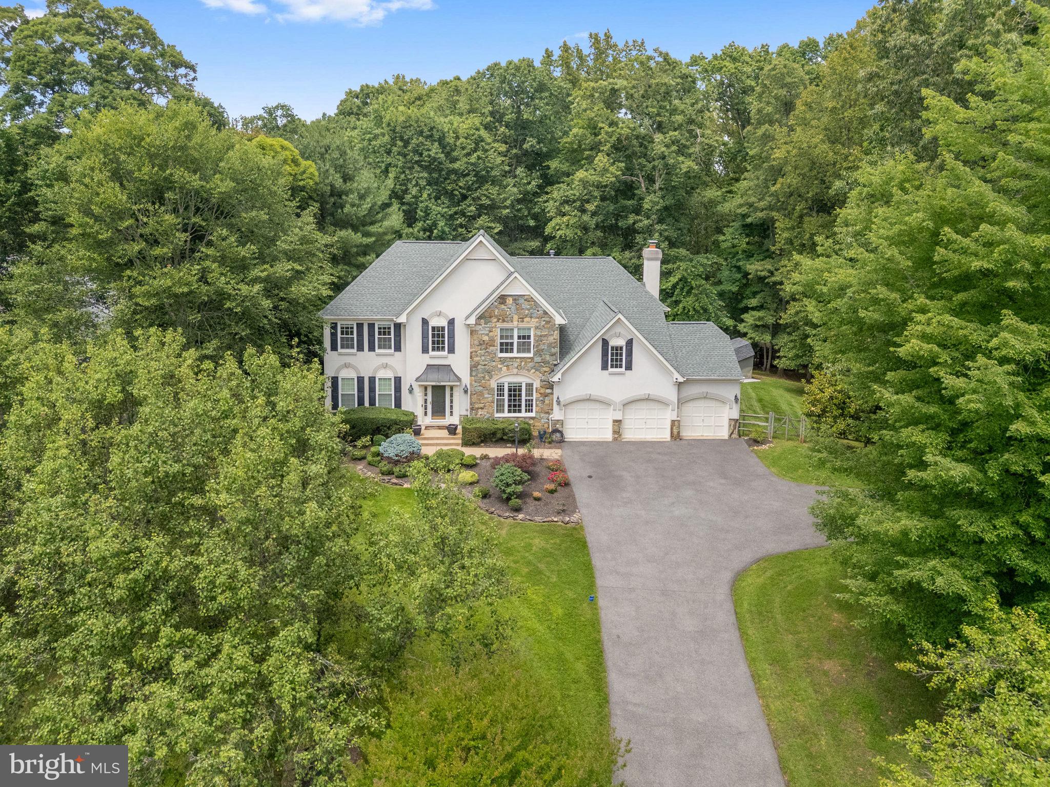 BRING ALL OFFERS! 🖊️ 
💫 HIGHLY RATED SCHOOL DISTRICT • PRIVACY & LUXURY • VALUE-PRICED FOR IMMEDIATE SALE💫

Welcome home to this stunning luxury estate, beautifully nestled among the trees on a serene 1.58-acre lot. Offering 4 bedrooms, 4.5 bathrooms, and a 3-car garage, this immaculate residence seamlessly blends sophisticated design with premium mechanics, offering ultimate privacy without isolation.

Premium Capital Improvements & Peace of Mind:
Power Security: 2024: Generac backup generator system
2023:Hot water heater, 2024:Washer and Dryer
2022: 20 premium Thompson Creek windows; asphalt driveway fully repaved (3" cap) 
2023:Whole home water softener, 2024: 86 Gallon Well Tank
2021: Detached storage shed; custom multi-level Trex deck with integrated lighting; stamped concrete patio and built-in fire pit
Roof: Approximately 10 years old

Elegant Living Spaces
Inside, a grand two-story foyer with warm hardwood flooring and a prominent staircase welcomes you into an elegant living room filled with natural light, plush carpet, and classic crown molding. The formal dining room features dual bay windows showcasing tranquil, wooded views.
The gourmet kitchen is a chef’s dream, boasting gleaming granite countertops, pristine white 42” cabinetry, a designer backsplash, a large pantry, double wall ovens, a smart refrigerator, and a center island with a gas cooktop. Earth-toned tile floors flow into a sunroom with a soaring cathedral ceiling and a wall of windows. Sliding glass doors lead to the spectacular multi-level deck and custom stamped concrete patio with a fire pit, an idyllic backyard oasis with dedicated garden and play areas surrounded by majestic woodlands, perfectly combining indoor and outdoor entertaining.

The adjacent family room centers around a dramatic floor-to-ceiling stone fireplace, complemented by a private home office with built-in bookcases, a powder room, and a practical mudroom.

Upper & Lower Level Retreats
The upper-level owner’s suite features a deep tray ceiling, a walk-in closet with custom organizers, and a romantic three-sided gas fireplace shared with a private sitting area. The luxury en-suite bath features a dual-sink vanity, a Jacuzzi tub, and a glass-enclosed shower. Three additional spacious bedrooms feature lighted ceiling fans and share either a private bath or a well-appointed Jack-and-Jill bath.

The finished walk-up lower level features a massive multipurpose recreation room zoned for games, exercise, and media/theater space, plus a full bath. Two additional finished rooms offer total flexibility for guest quarters or a second office, while a large unfinished utility room/workshop provides abundant storage.
Secluded Yet Connected; Enjoy effortless access to Route 234, the Prince William Parkway, I-95, Express Lanes, and the VRE, putting shopping, dining, and commuter routes minutes away. Explore nearby Prince William Forest Park, offering 15,000 acres of outdoor recreation. 
Schedule your showing today! 🏡 ☀️
