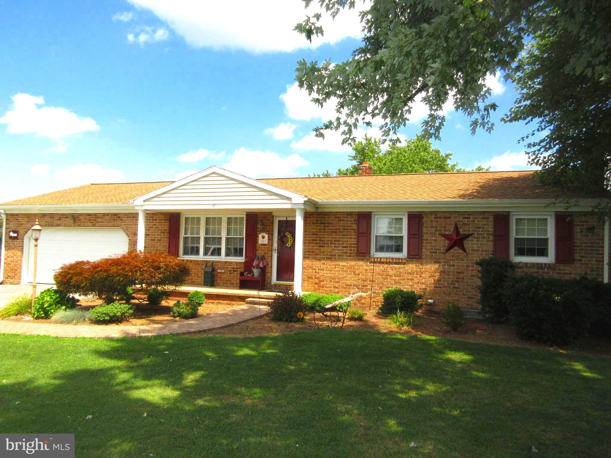 Solid built brick and vinyl Rancher on over a 1 acre lot.  Terrific views and home backs up to cornfields.  Open/traditional floor plan w/large living room and kitchen & dining areas, spacious "L" shaped Rec room with fireplace w/woodstove, maintenance free deck, partially fenced in rear yard, new roof in 2021, shed, central air and more.  Public water to house.  (Living S. F. is an estimate.  Buyers agent and Buyer to verify)