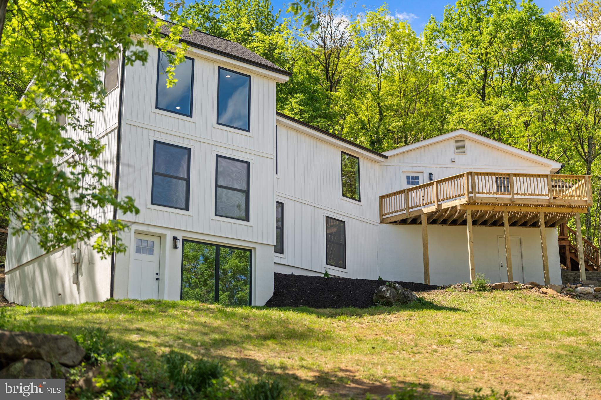 Completely reimagined from top to bottom, this 2,800 sq ft modern farmhouse in the sought-after Shenandoah Farms community of Front Royal is the one you've been waiting for. Set on 1.64 private acres atop Drummer Hill with sweeping long-range views of the Shenandoah Valley and surrounding Blue Ridge Mountains, this property delivers the perfect blend of luxury finishes and mountain living.

The heart of the home is a stunning open-concept kitchen and great room featuring vaulted ceilings, skylights, and exposed wood beams. The chef's kitchen shines with a custom wood island, Taj Mahal countertops, stainless appliances, a pot filler, and a handcrafted range hood, all flowing into a bright dining room with board-and-batten wainscoting and a spacious living area with direct access to the deck.

The primary suite is a true retreat with treetop views from every window, a double vanity, walk-in marble tile shower, brass fixtures, and a custom built-in closet. Every bathroom has been finished with designer tile, gold fixtures, and premium vanities, no detail was overlooked. A custom mudroom with built-in storage sits right off the entry for everyday convenience.

Step outside to two brand-new decks, the upper deck alone is worth the trip, offering unobstructed panoramic views of the valley and mountain ridgelines that stretch as far as the eye can see. The walk-out lower level adds flexible space for a guest suite, home gym, or recreation room with its own private entrance. Home includes additional rooms that give you real flexibility, set them up as a dedicated home office, a fitness or yoga studio, a playroom, a creative studio, or a media room. Whether you're working remotely, hosting family, or simply need space to spread out, this home adapts to your lifestyle.

As a Shenandoah Farms property owner, you'll enjoy access to the community's lakes, the Shenandoah River, and all the outdoor recreation the Northern Shenandoah Valley has to offer, minutes from Skyline Drive, hiking trails, wineries, and downtown Front Royal.

Whether you're looking for a full-time residence, weekend getaway, or investment property, this home delivers it all. Properties like this don't last, schedule your showing today.