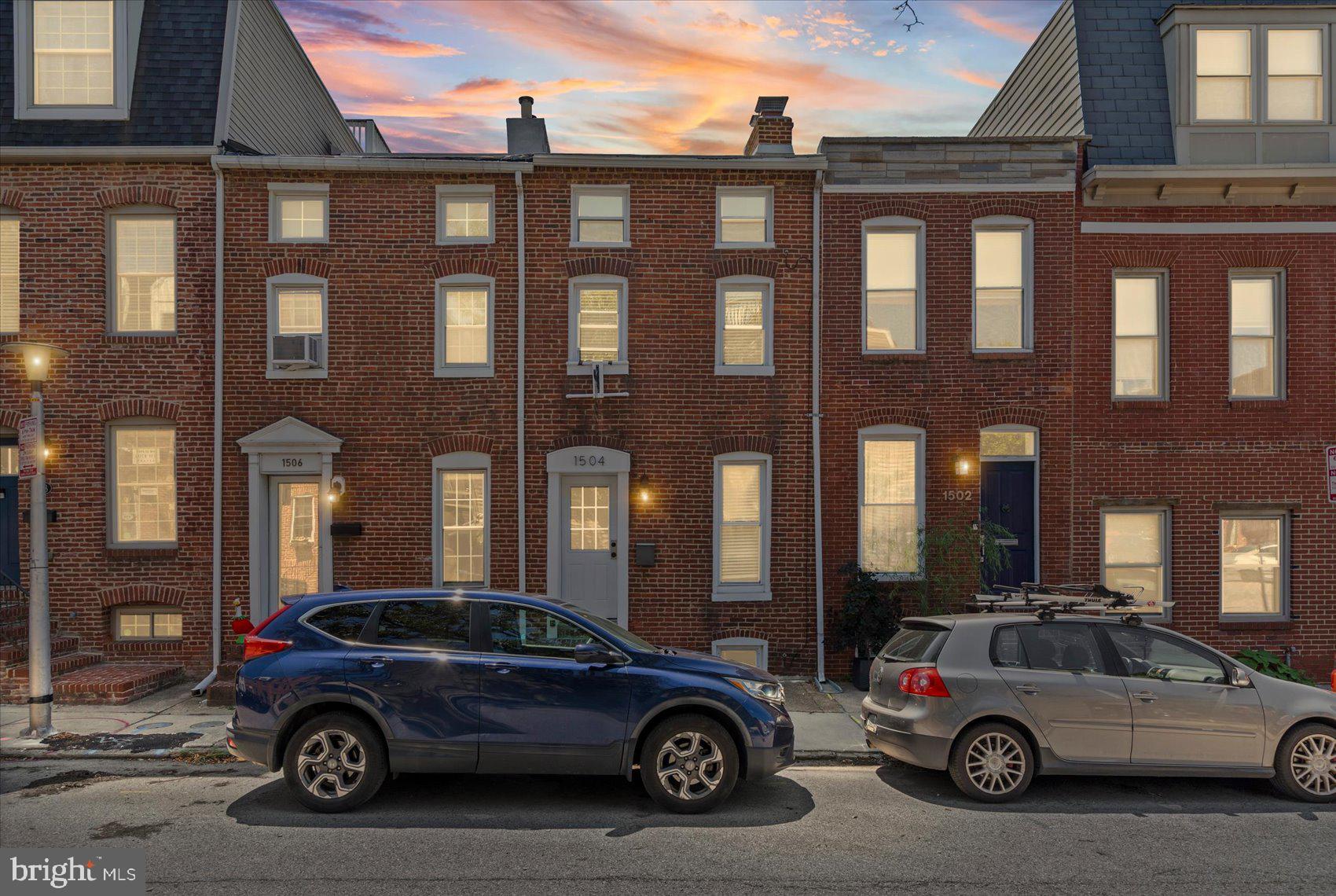 Beautifully renovated and move-in ready, this 3-bedroom, 1.5-bath brick townhome is located in the highly desirable Riverside neighborhood of South Baltimore. Nestled just south of Federal Hill, Riverside is a historic, highly walkable community centered around Riverside Park and known for its tree-lined streets, classic 19th-century brick rowhomes, strong sense of community, and convenient access to local dining, waterfront attractions, and major commuter routes. The neighborhood attracts a diverse mix of young professionals, families, and long-term homeowners.

Situated on a charming tree-lined street, the home welcomes you with gleaming hardwood floors, a neutral color palette, abundant natural light, and an open, inviting floor plan. The main level features a spacious living room with an original fireplace that flows seamlessly into the dining room, creating an ideal space for everyday living and entertaining. Beyond the conveniently located half bath, the updated kitchen offers abundant cabinetry, stone countertops, stainless steel appliances, and a deep stainless steel sink positioned beneath a window overlooking the rear yard.

The second level includes a convenient laundry area with shelving, a generously sized secondary bedroom with access to the updated full bath featuring a tiled walk-in shower with built-in bench seating, and a spacious primary bedroom complete with an original fireplace and a walk-in closet.

The third level offers a private third bedroom with a large closet and additional space suitable for a sitting area or home office. A glass door provides access to the rooftop deck, offering additional outdoor living space ideal for relaxing or entertaining.

The unfinished lower level provides clean, dry storage space along with the home's utility area and offers potential for future customization. Outside, a rear deck leads to a private patio and an off-street parking pad, providing both convenience and additional outdoor living space.

Overall, the property reflects quality renovations, functional living space, and a desirable location within one of South Baltimore's most sought-after neighborhoods, with convenient access to parks, restaurants, shopping, employment centers, and transportation corridors.